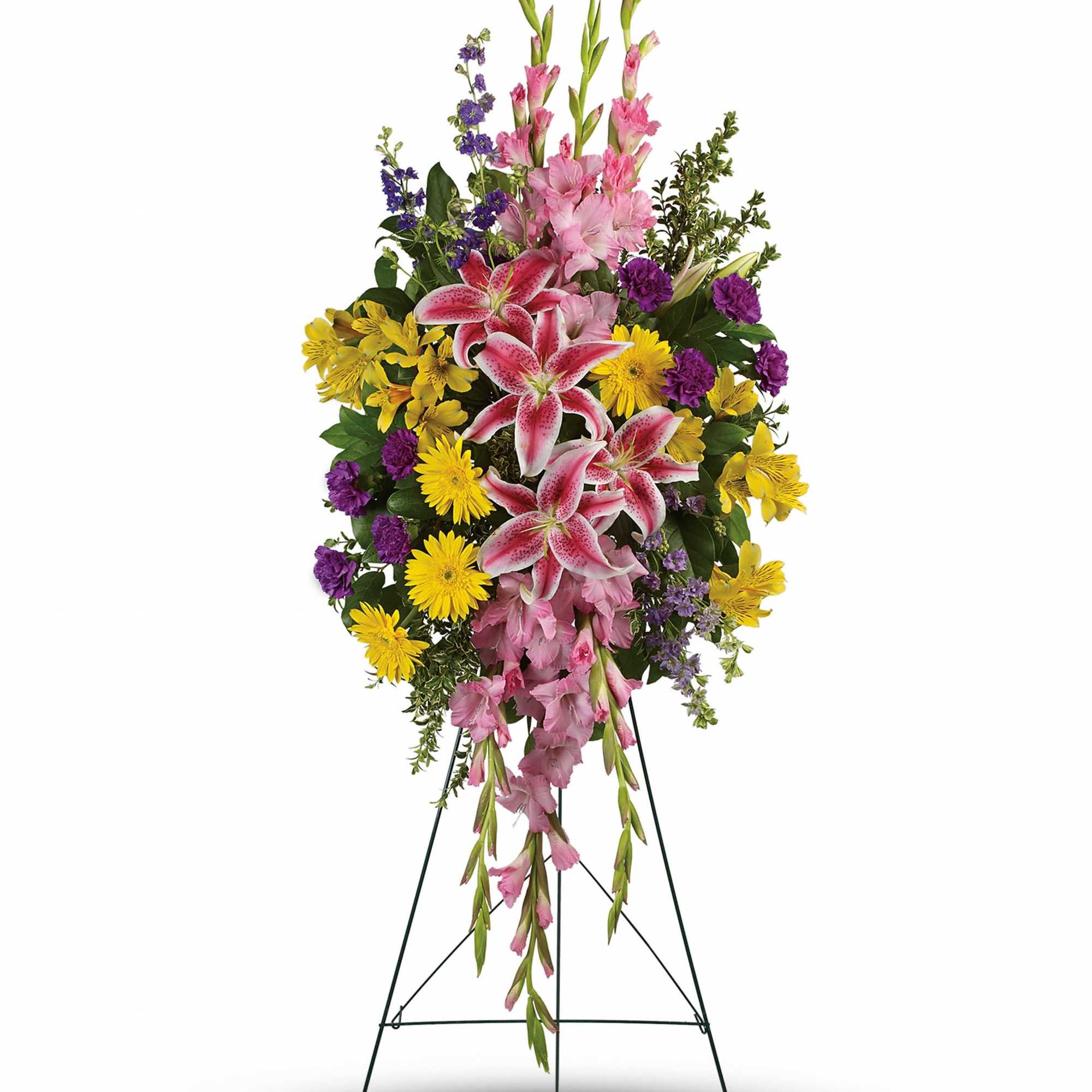 Tall standing spray of pink lilies, pink gladiolus, yellow daisies, and purple blooms on a metal easel.