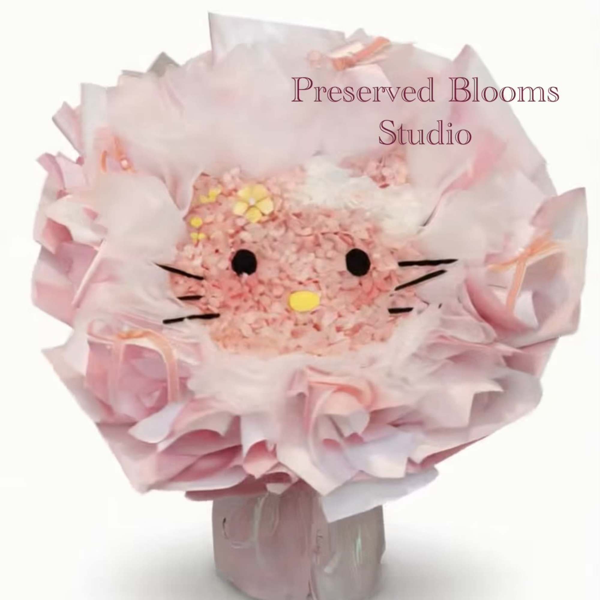 Round pink bouquet styled like a cat face, wrapped in layered pink paper.