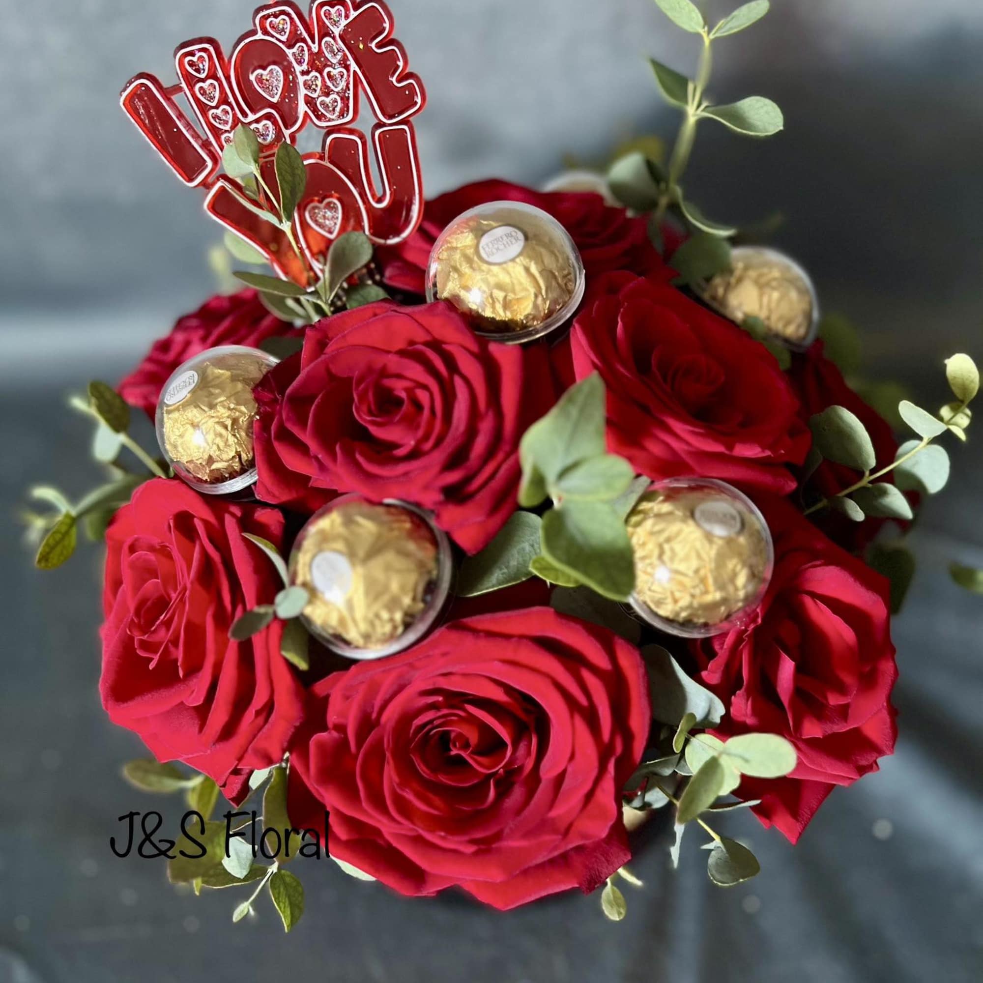 Red rose bouquet with Ferrero Rocher chocolates and an "I love you" topper