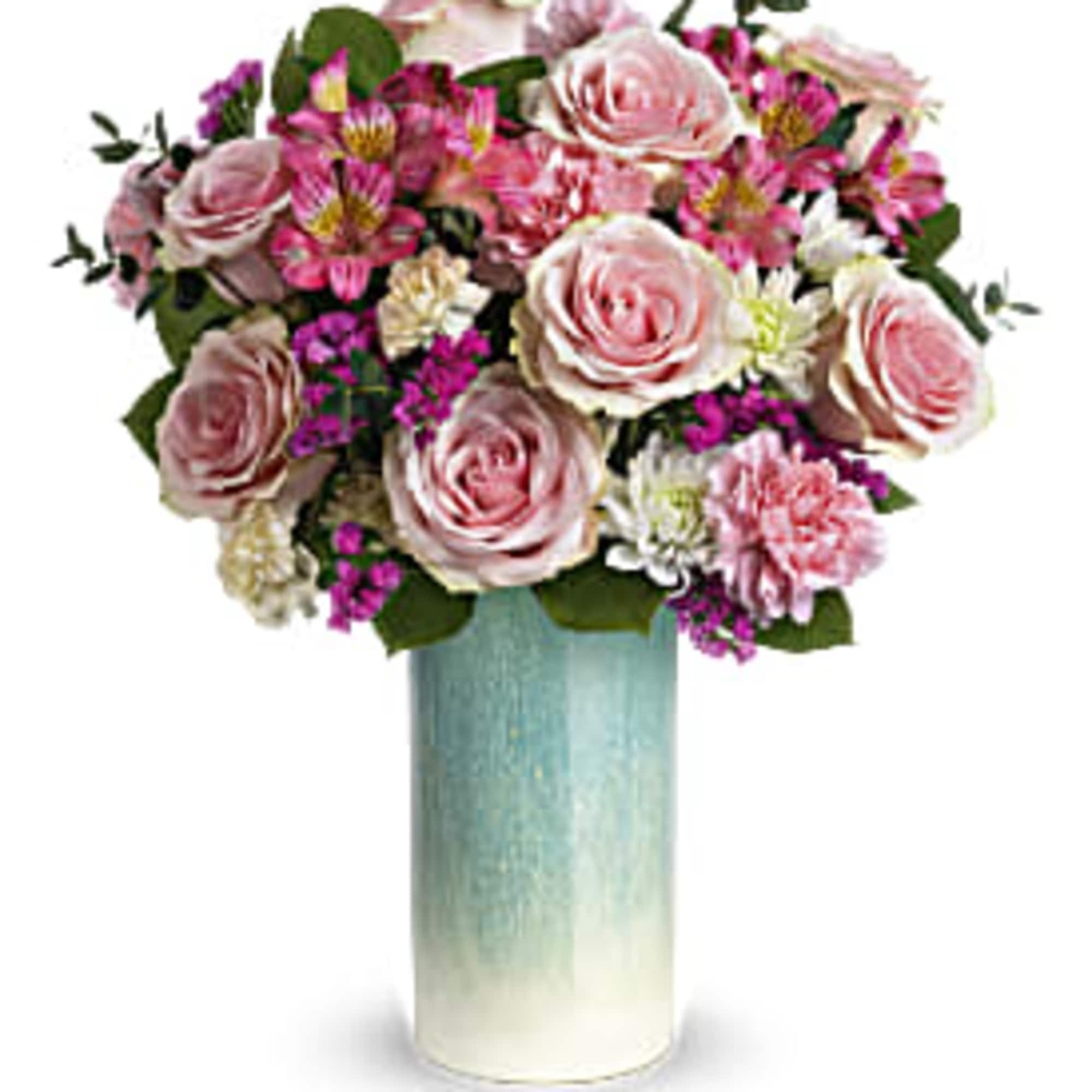 Pink and white roses, carnations, and mixed blooms arranged in a tall blue ceramic vase