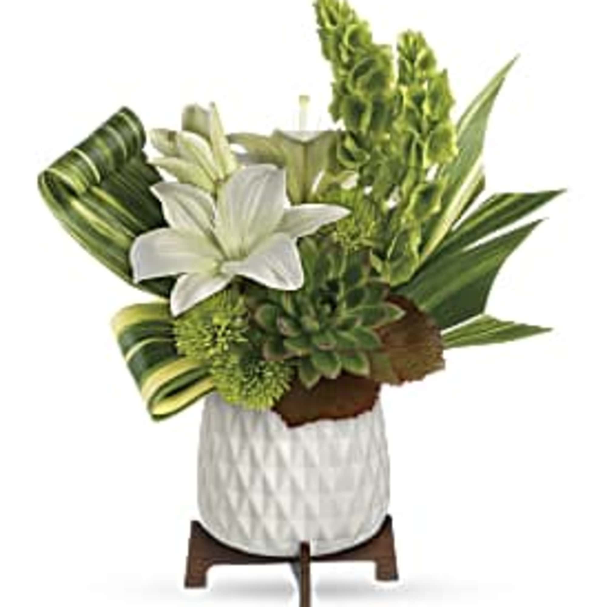 Compact white and green arrangement with lilies, succulents, and tall blooms in a white pot on a wooden stand