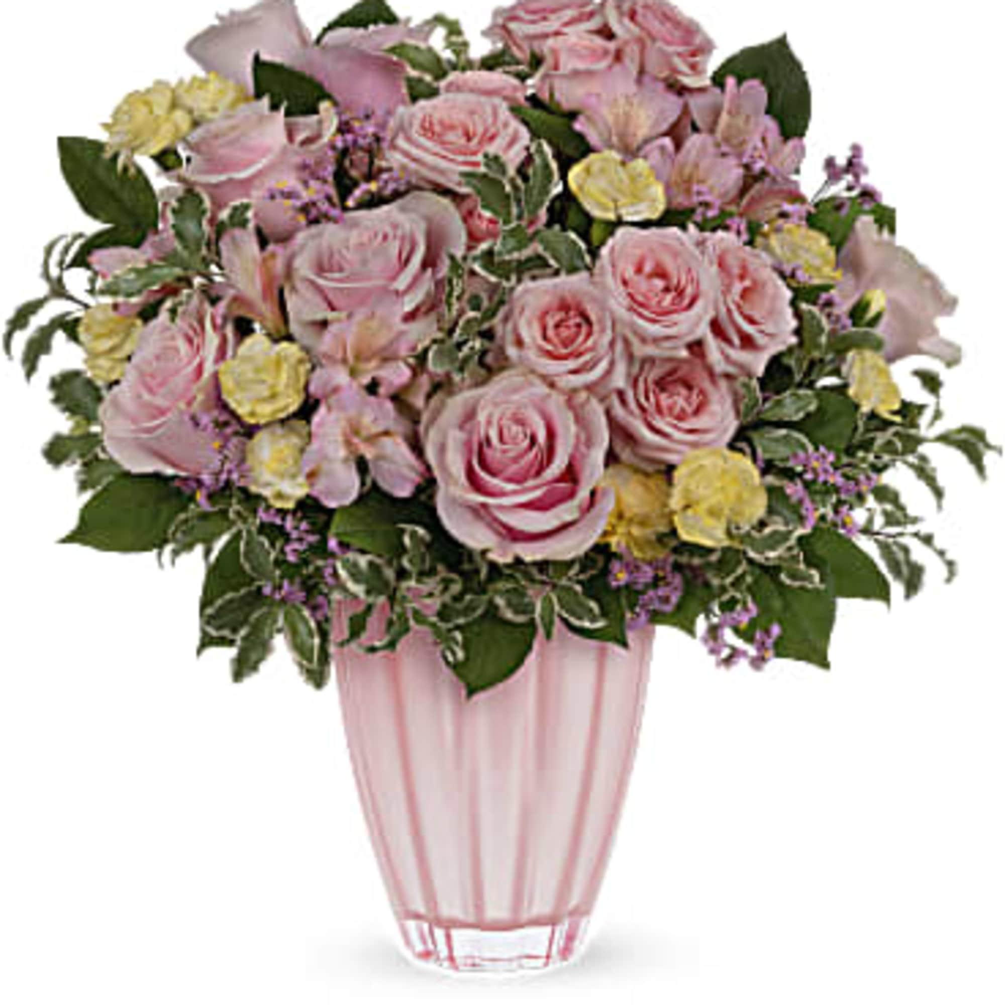 Pink and yellow mixed flower arrangement with roses in a pink glass vase