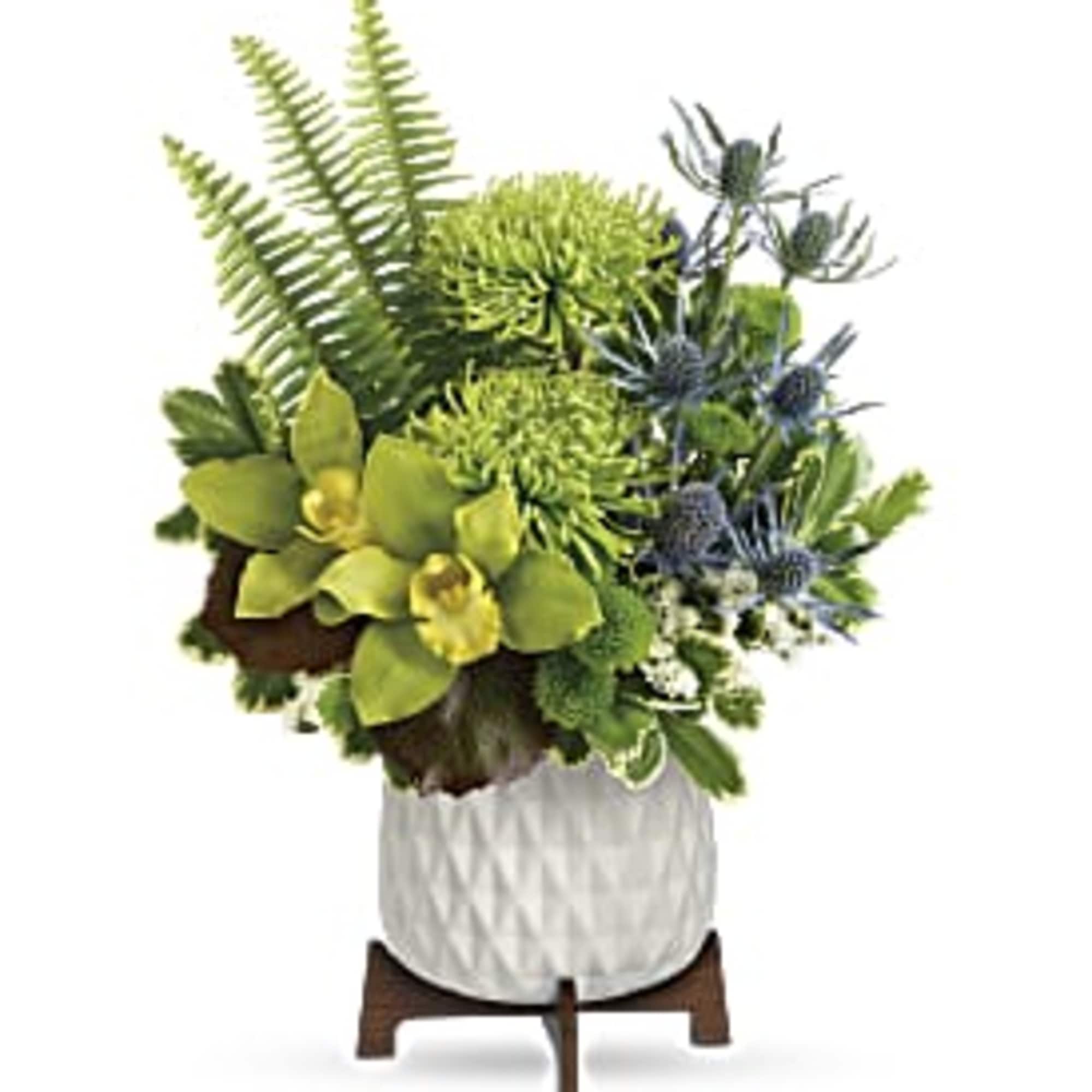 Compact green and blue floral arrangement with orchids and mums in a white pot on a wooden stand
