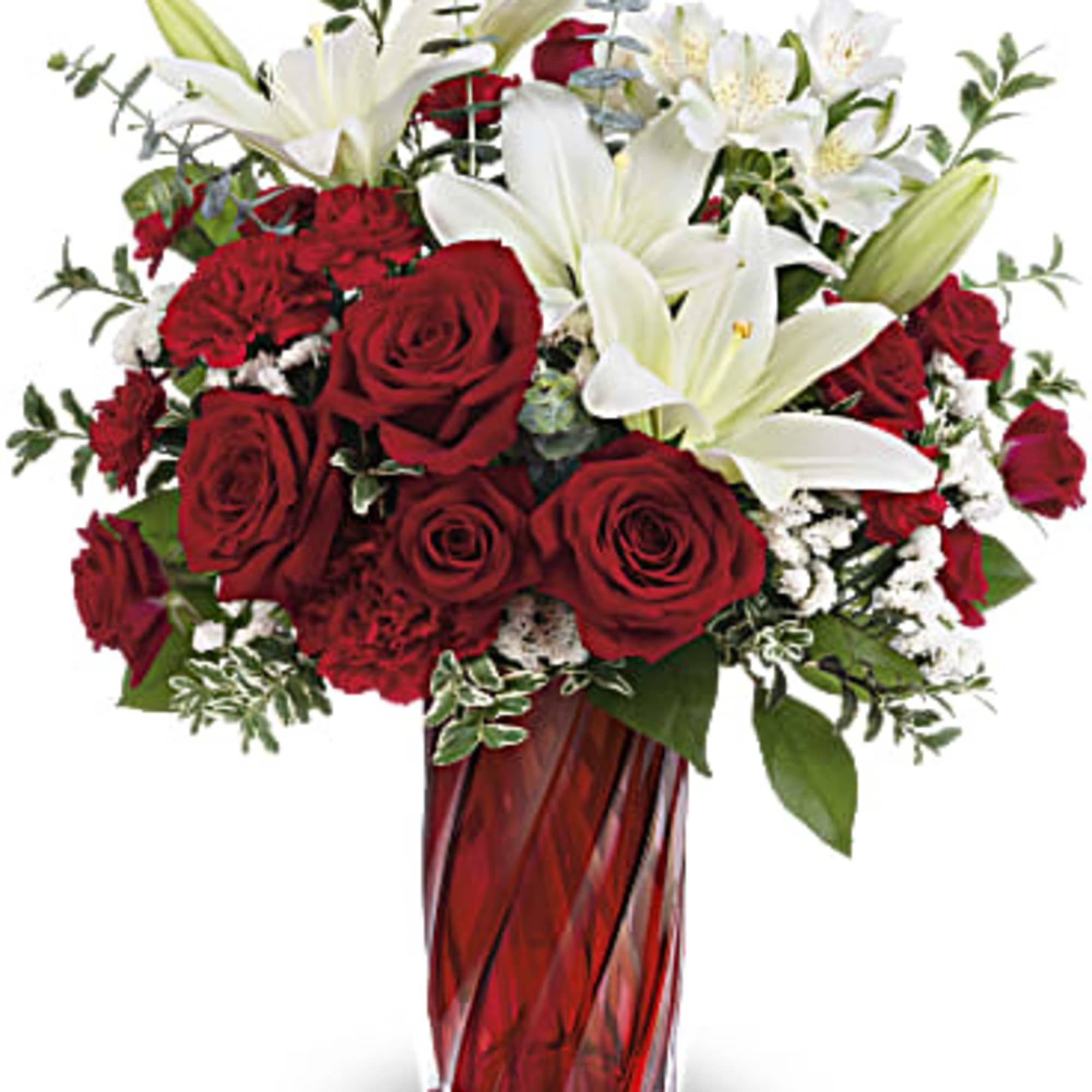 Red roses and carnations with white lilies in a tall red glass vase