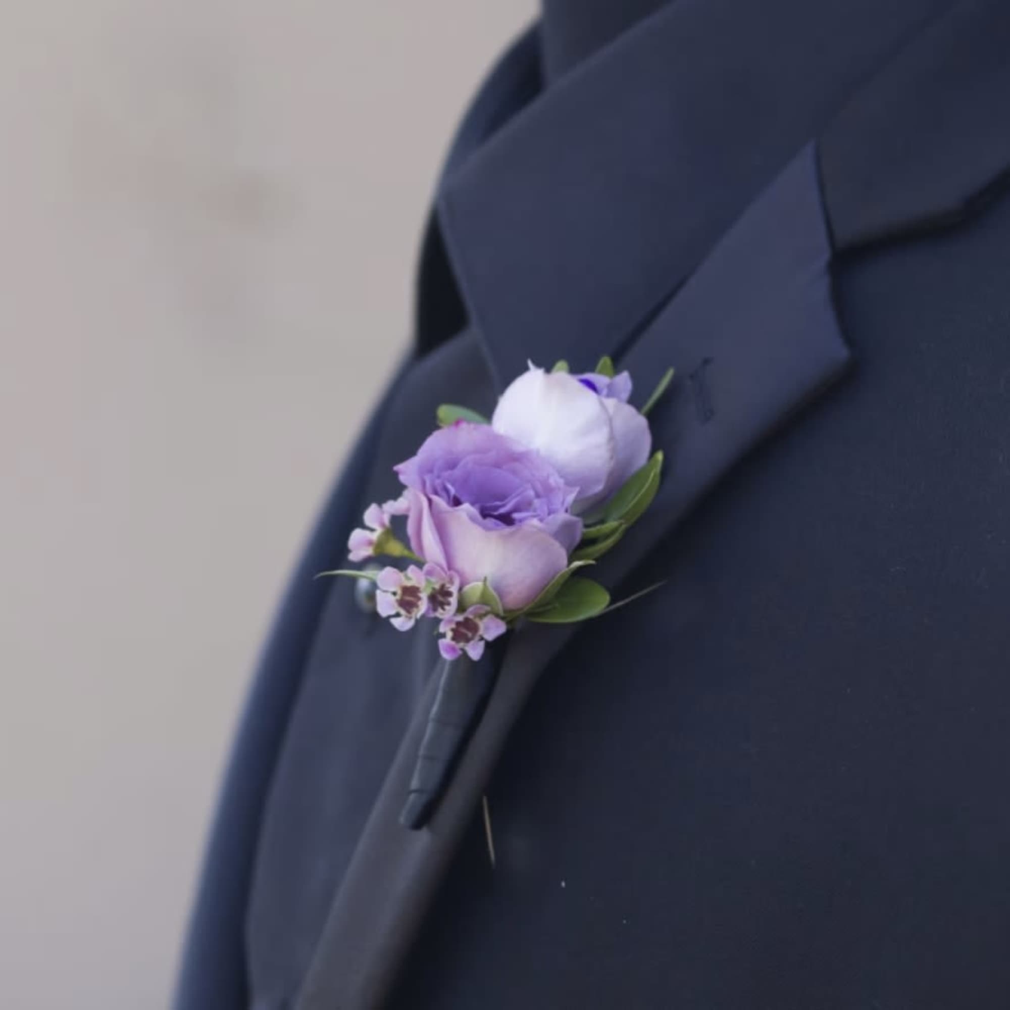 Lavender spray roses gathered into a compact wrist corsage give Charlotte a