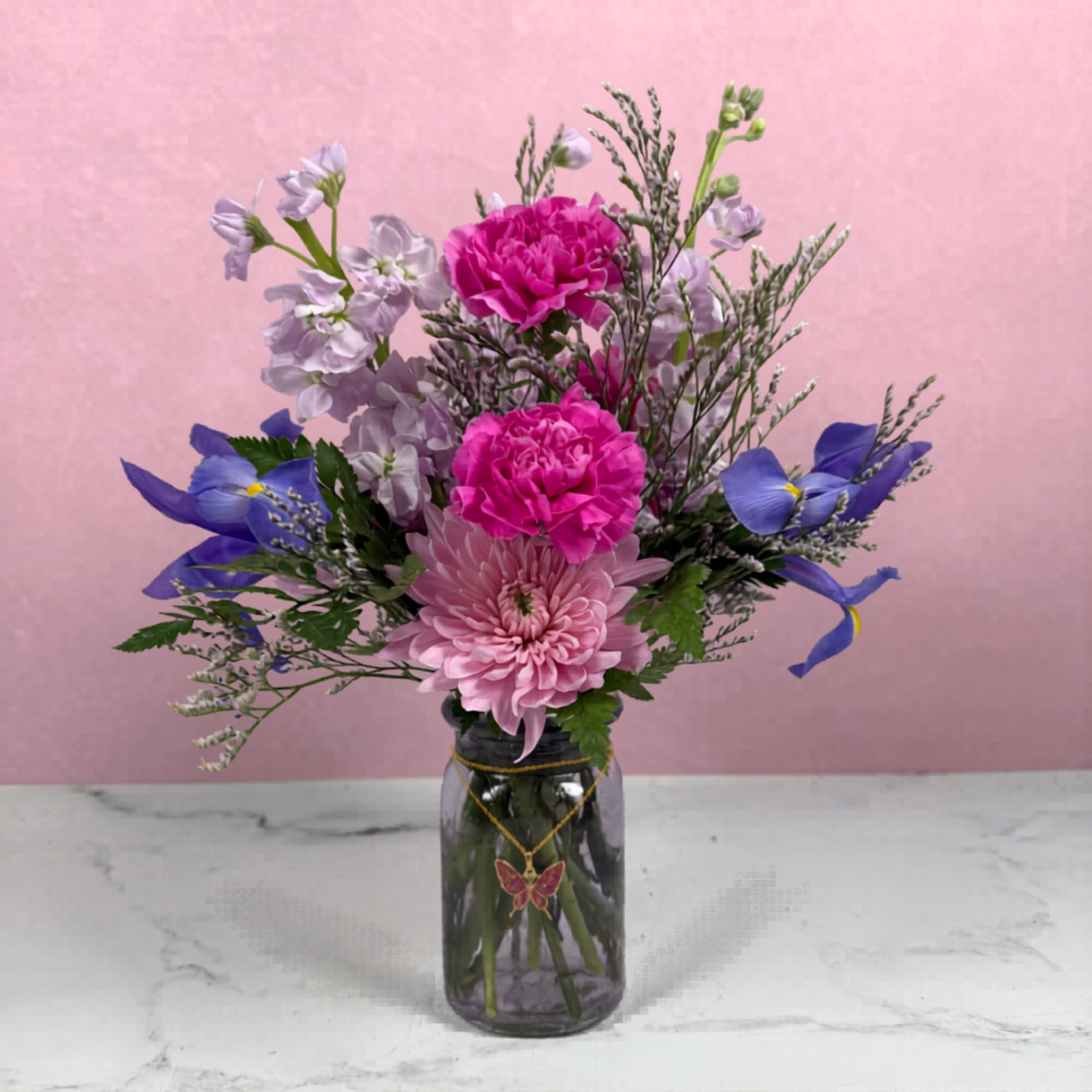 Soft and delicate purple and pink blooms are joined with airy filler
