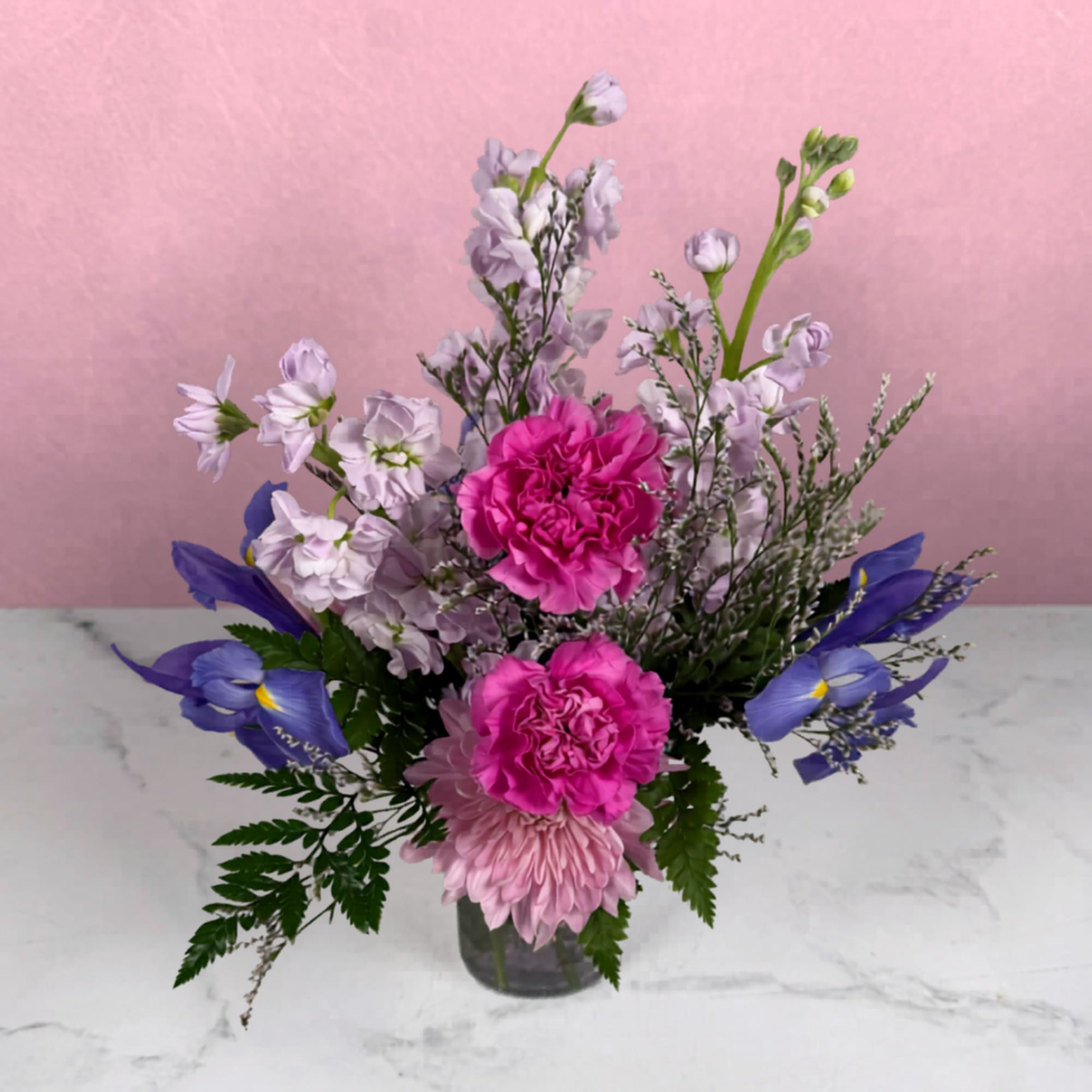 Soft and delicate purple and pink blooms are joined with airy filler