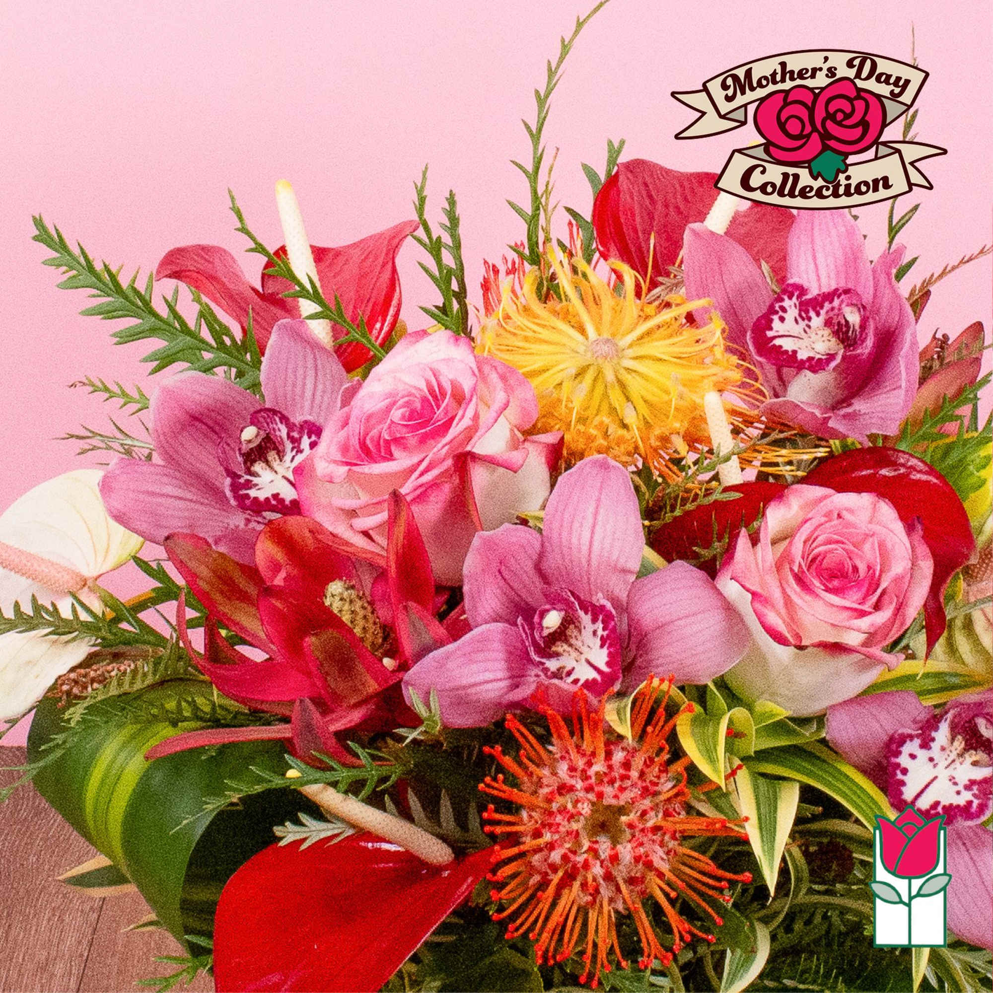 Vibrant arrangement of pink roses, orchids, and tropical blooms in pink, red, orange, and yellow tones