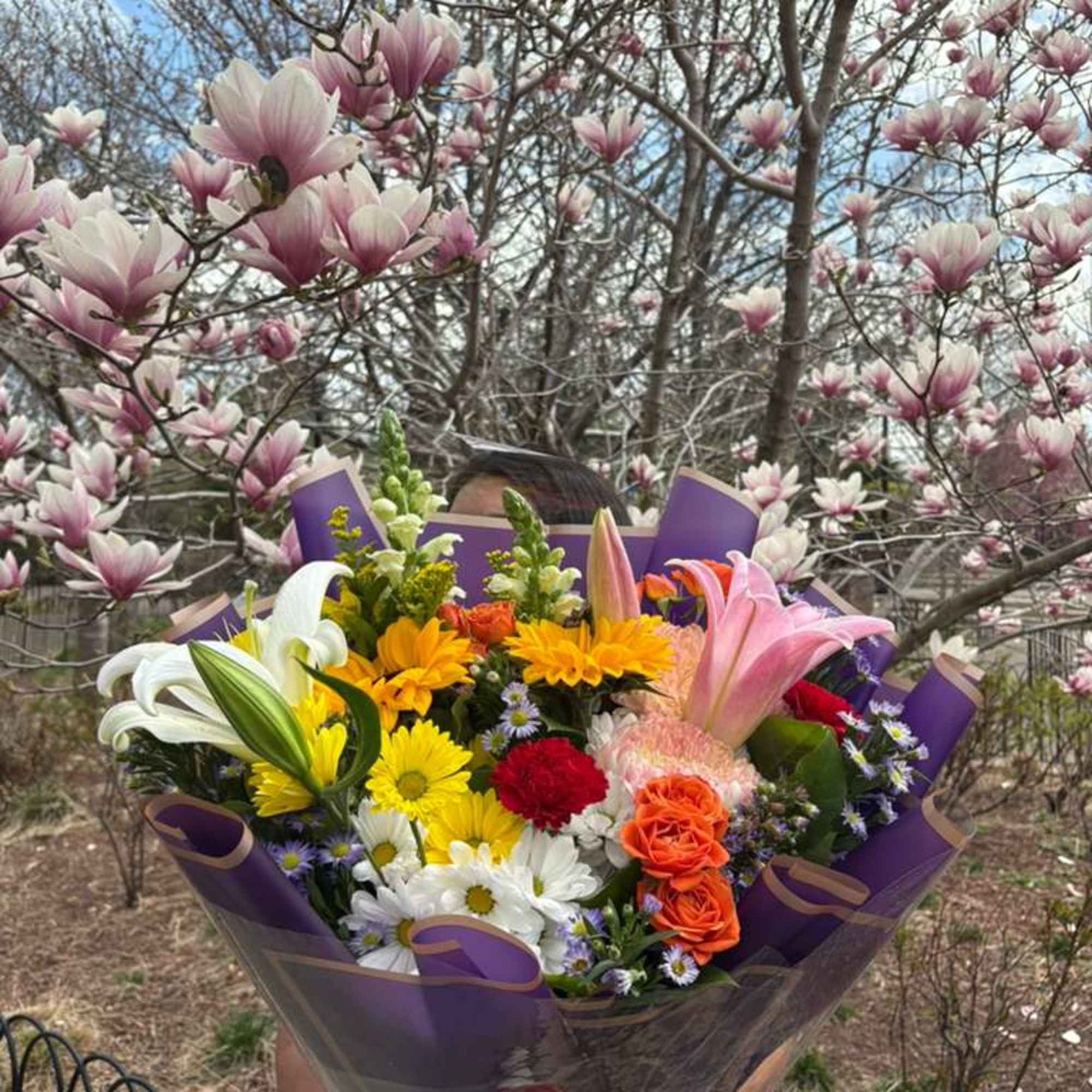 A cheerful bouquet with a mix of seasonal flowers. Designed, packaged, and