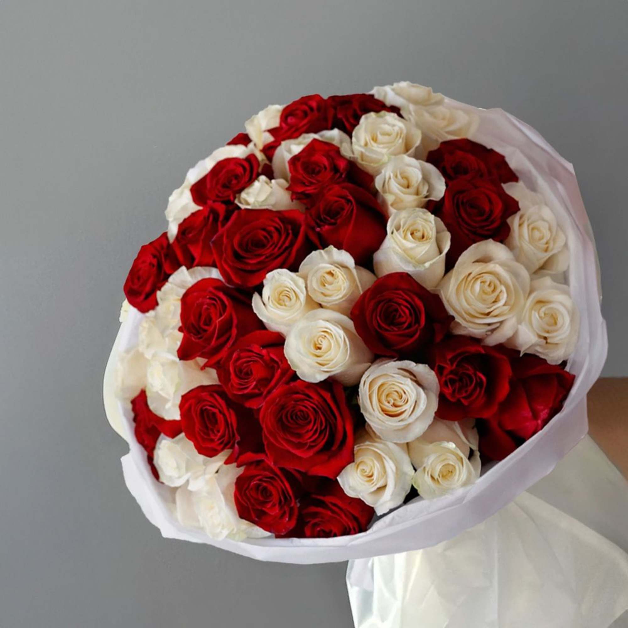 A striking harmony of passionate red and  white roses, beautifully wrapped