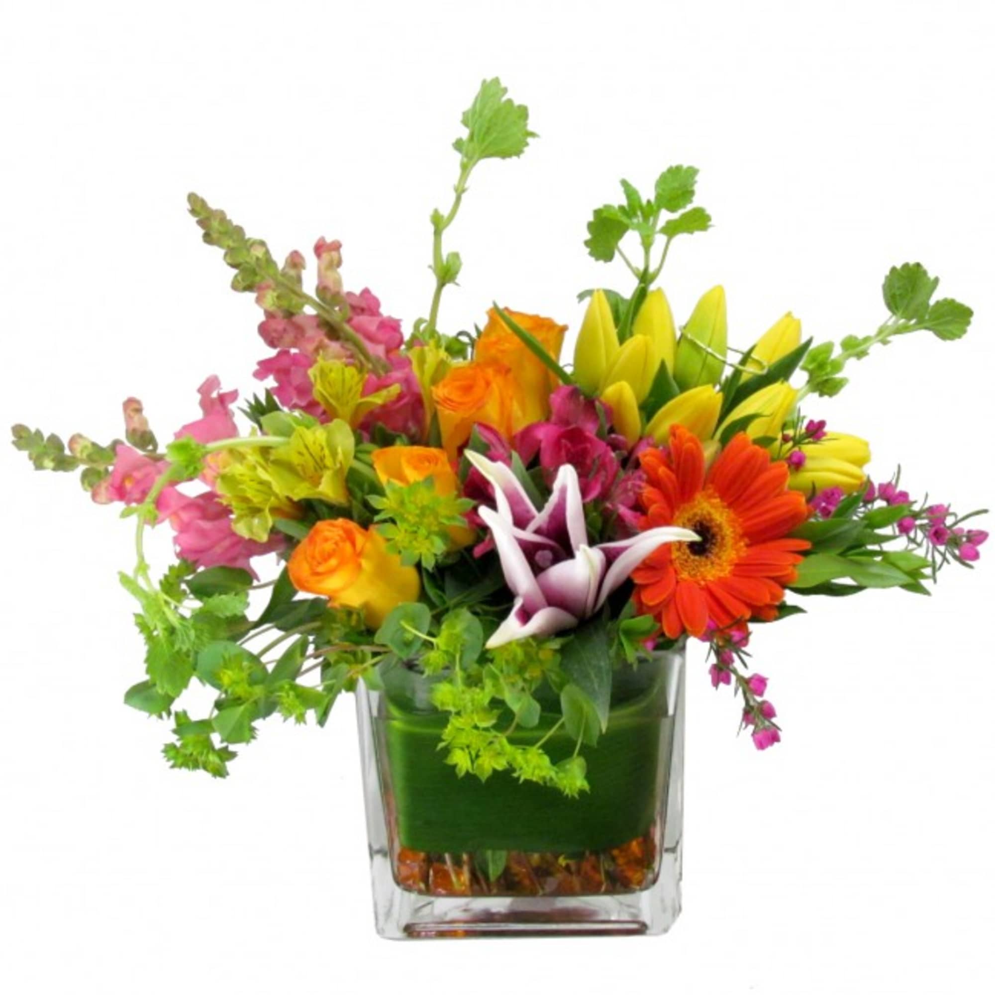 Bright mixed bouquet of yellow lilies, orange gerbera and roses in a clear glass cube vase