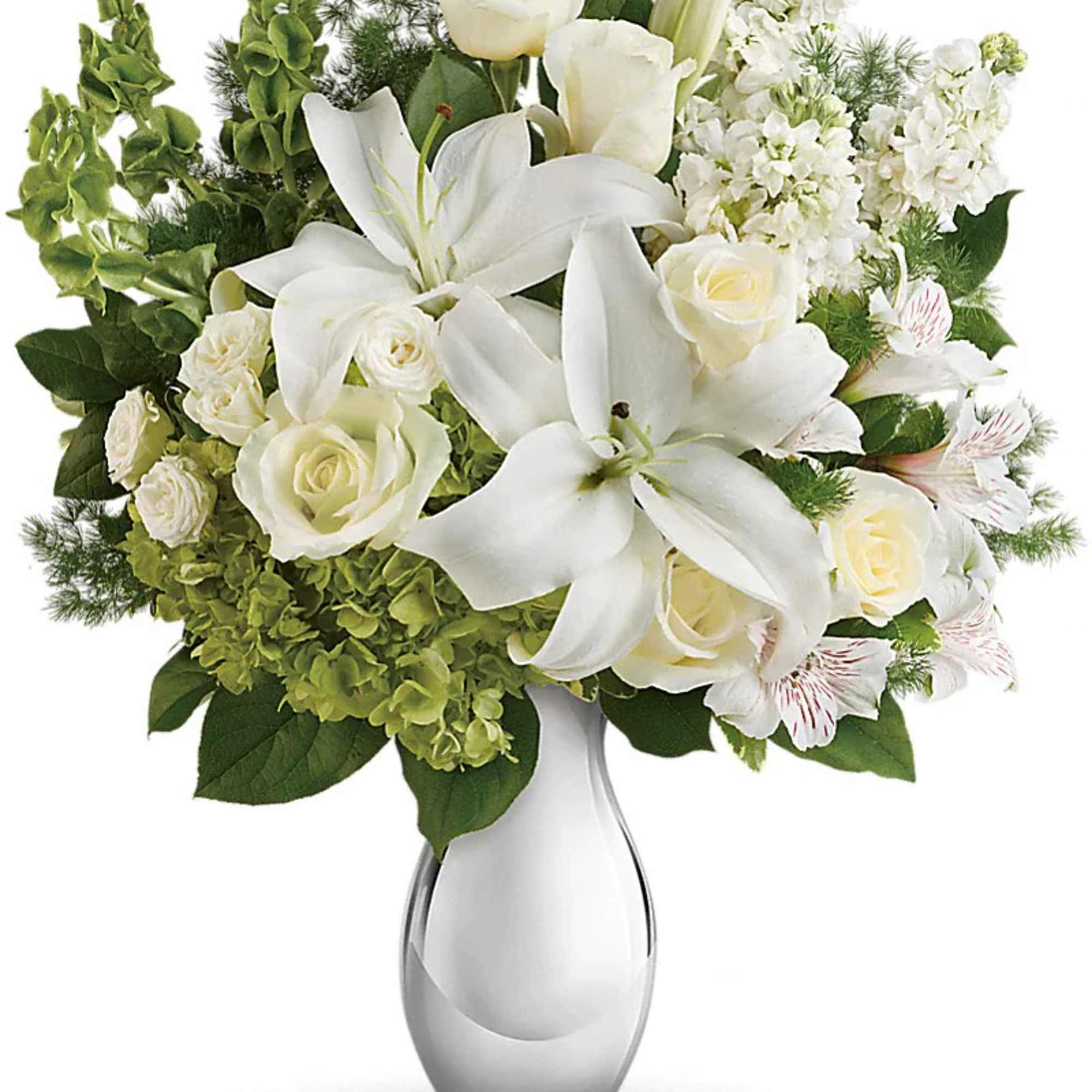 Tall white and green arrangement with lilies, roses, and hydrangeas in a glossy white and silver vase