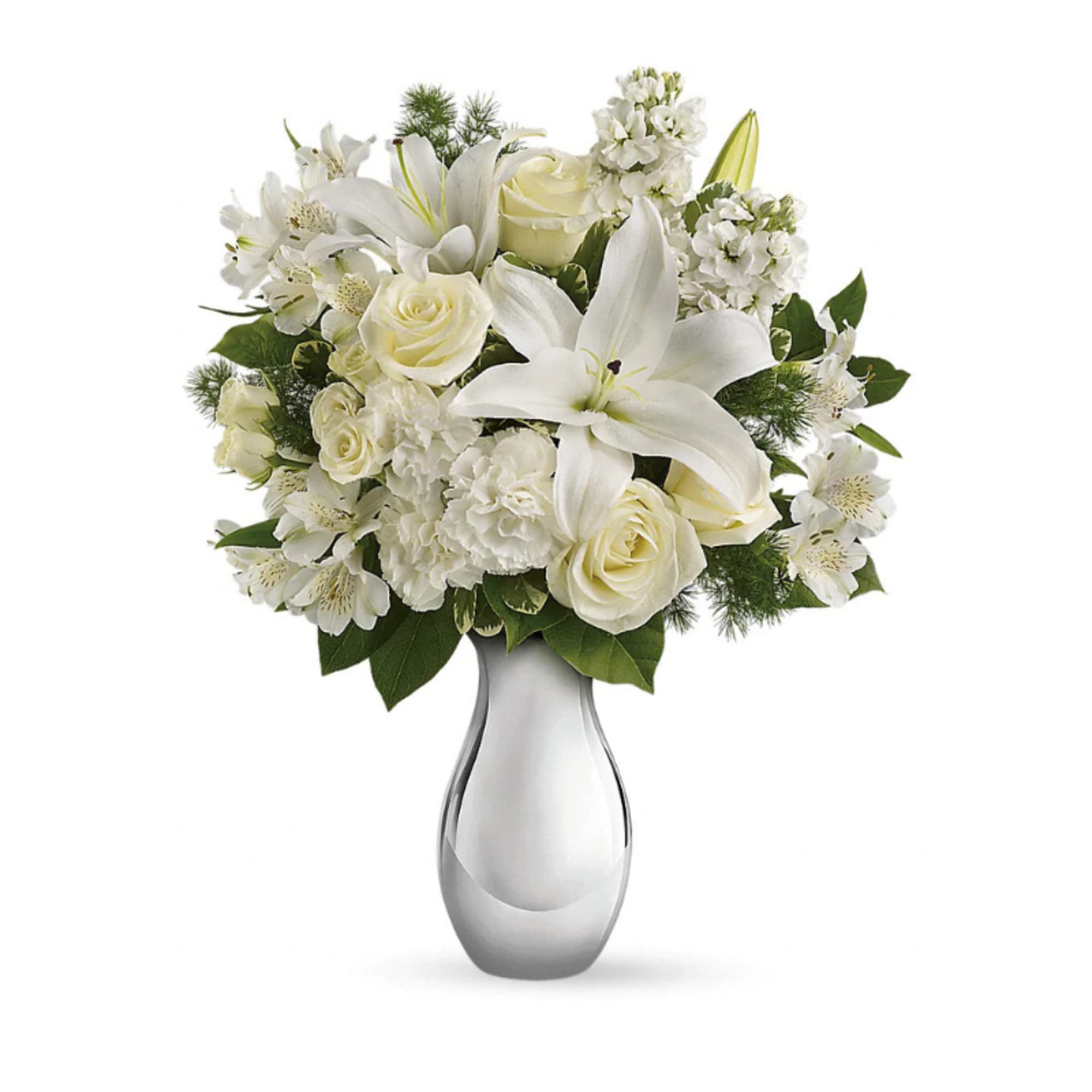 Arrangement of white lilies, roses, carnations, and other blooms in a silver vase