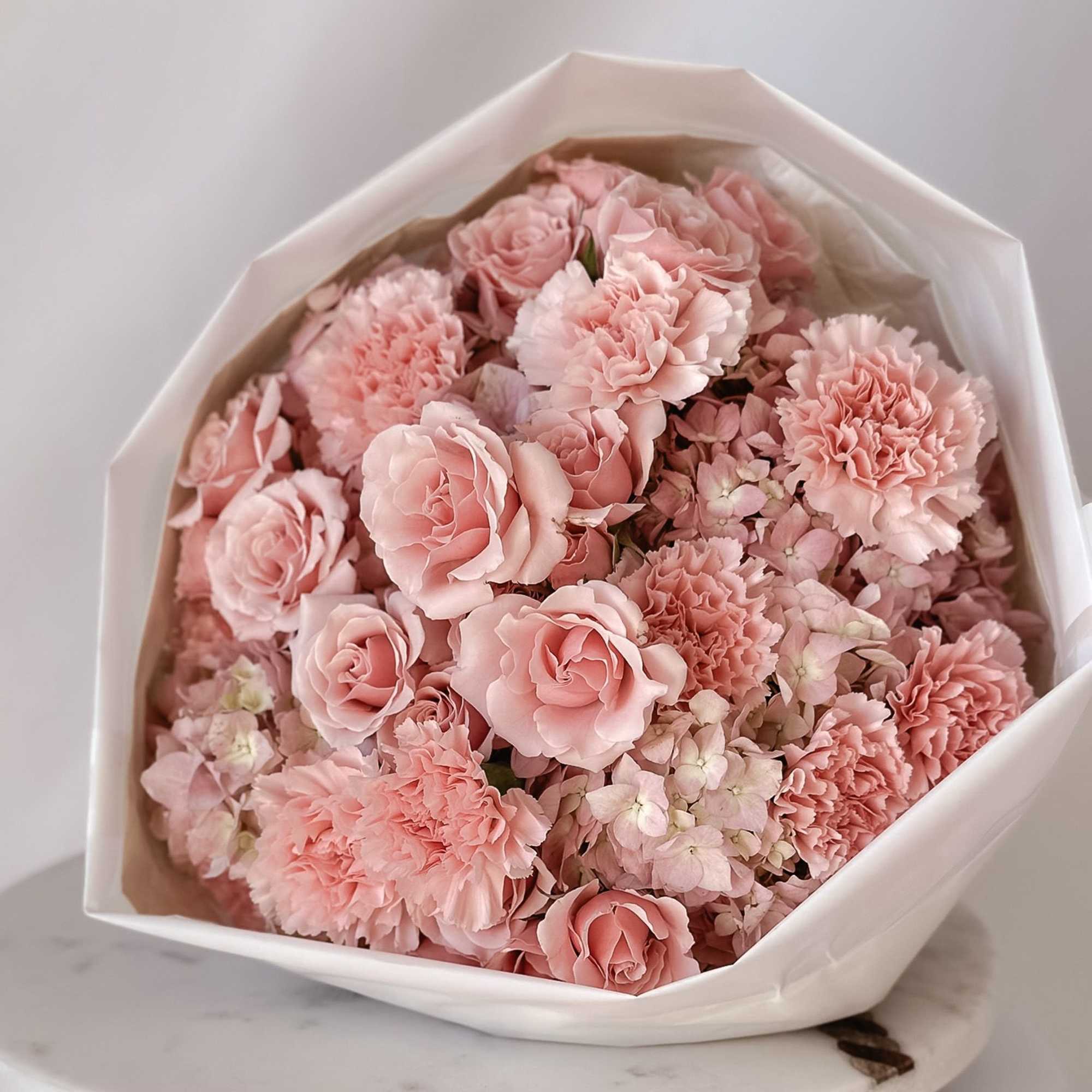 Our best-selling creation is designed to capture hearts. This round arrangement showcases