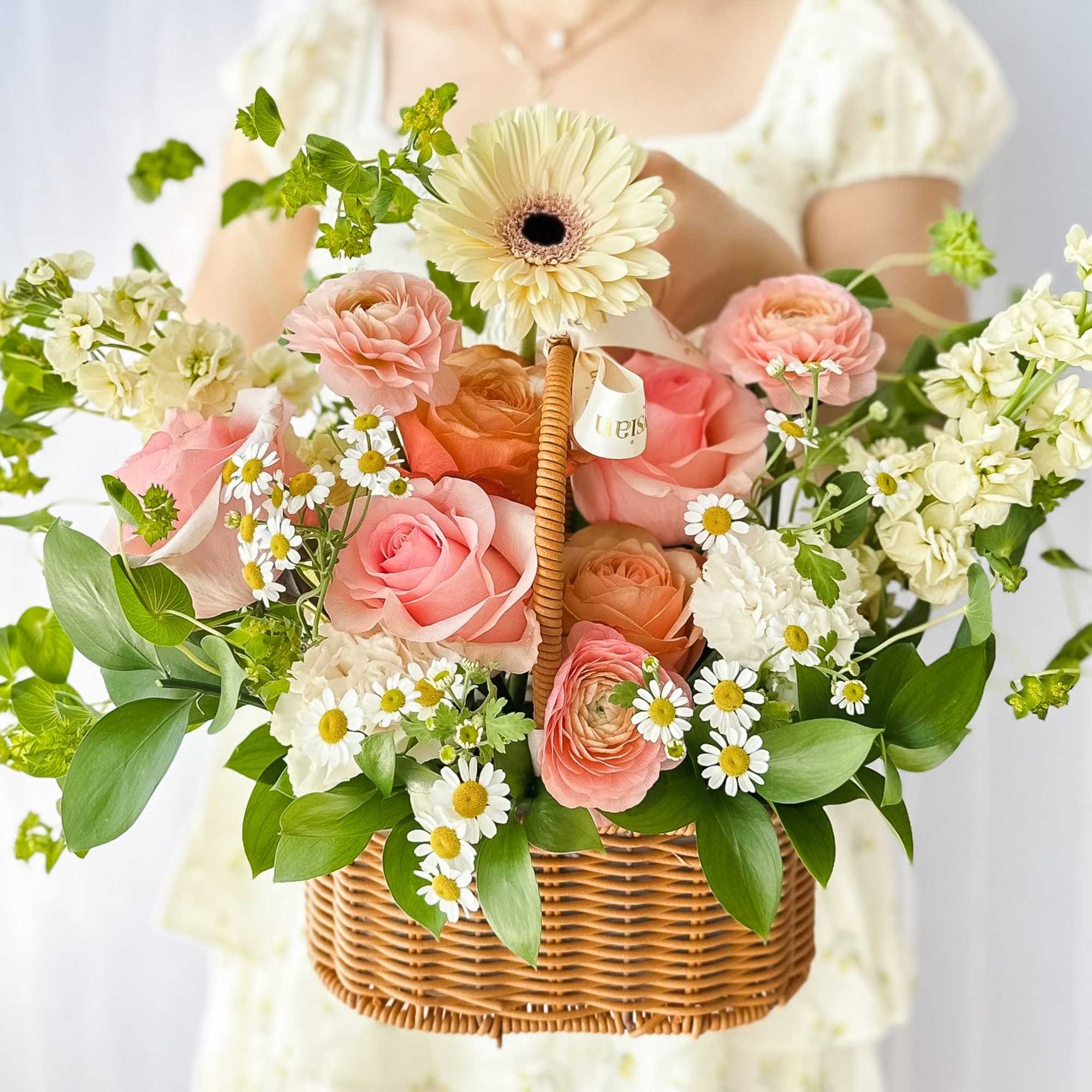 This beautiful flower basket captures the essence of a blooming garden, featuring