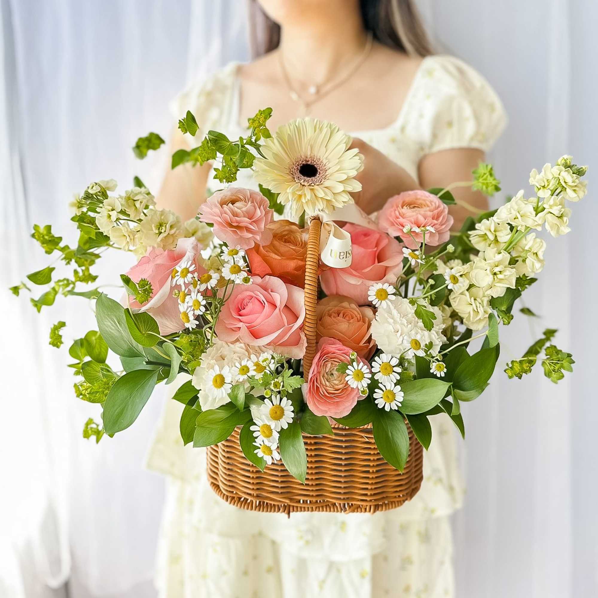 This beautiful flower basket captures the essence of a blooming garden, featuring