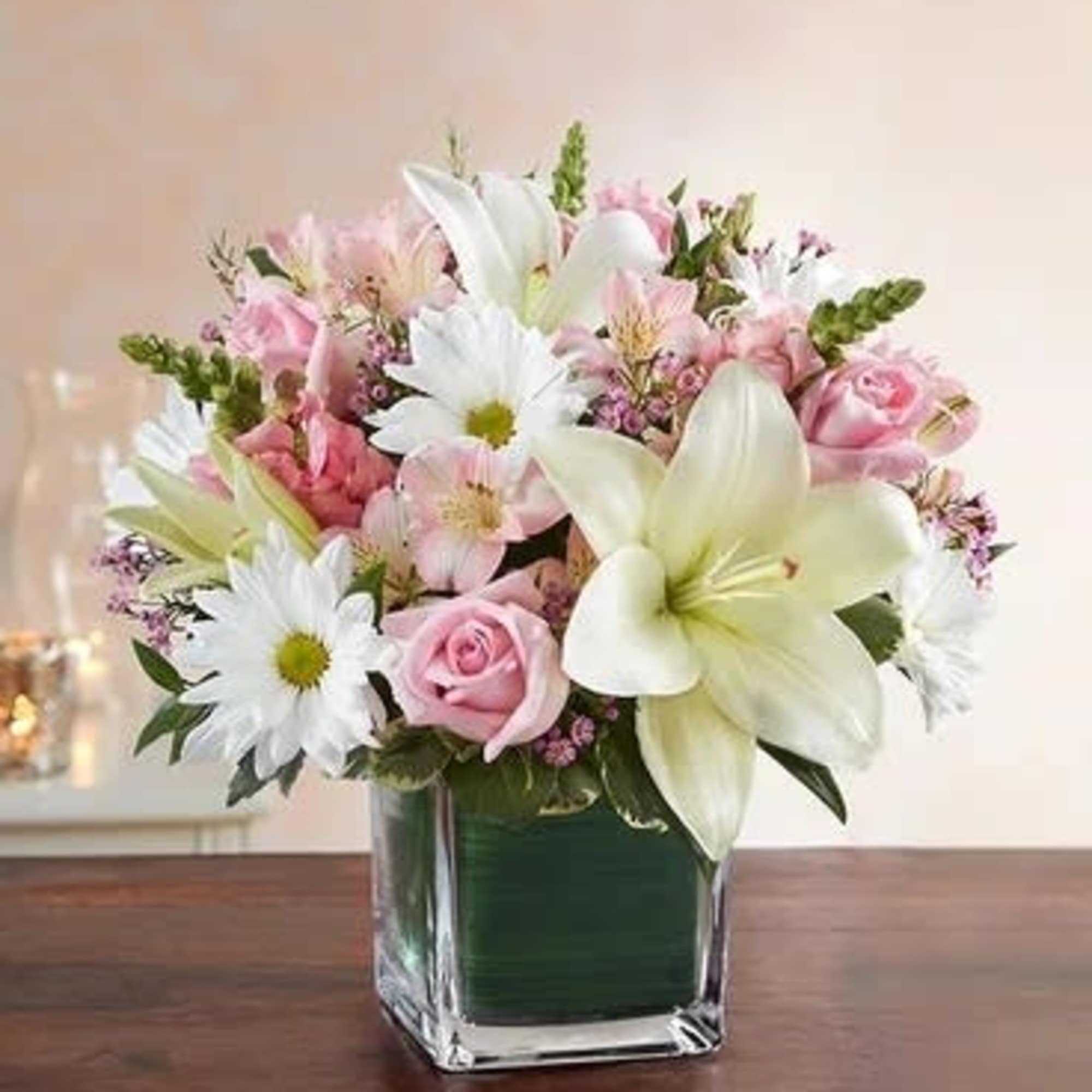 Pink and white mixed bouquet in a square glass vase