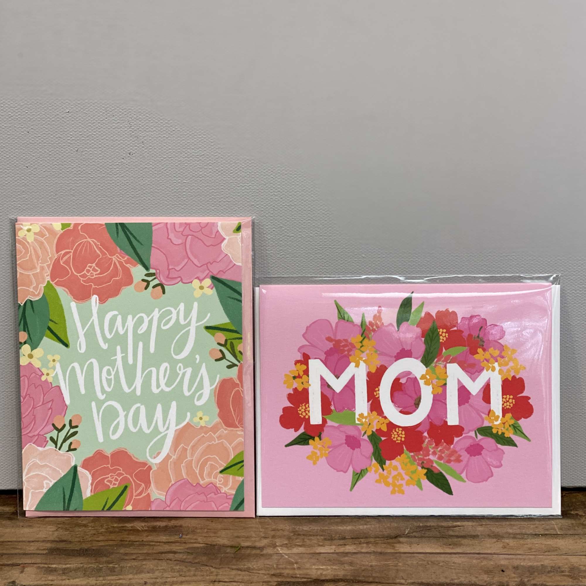 Two floral Mother's Day greeting cards, one reading Happy Mother's Day and one with MOM on a pink background.