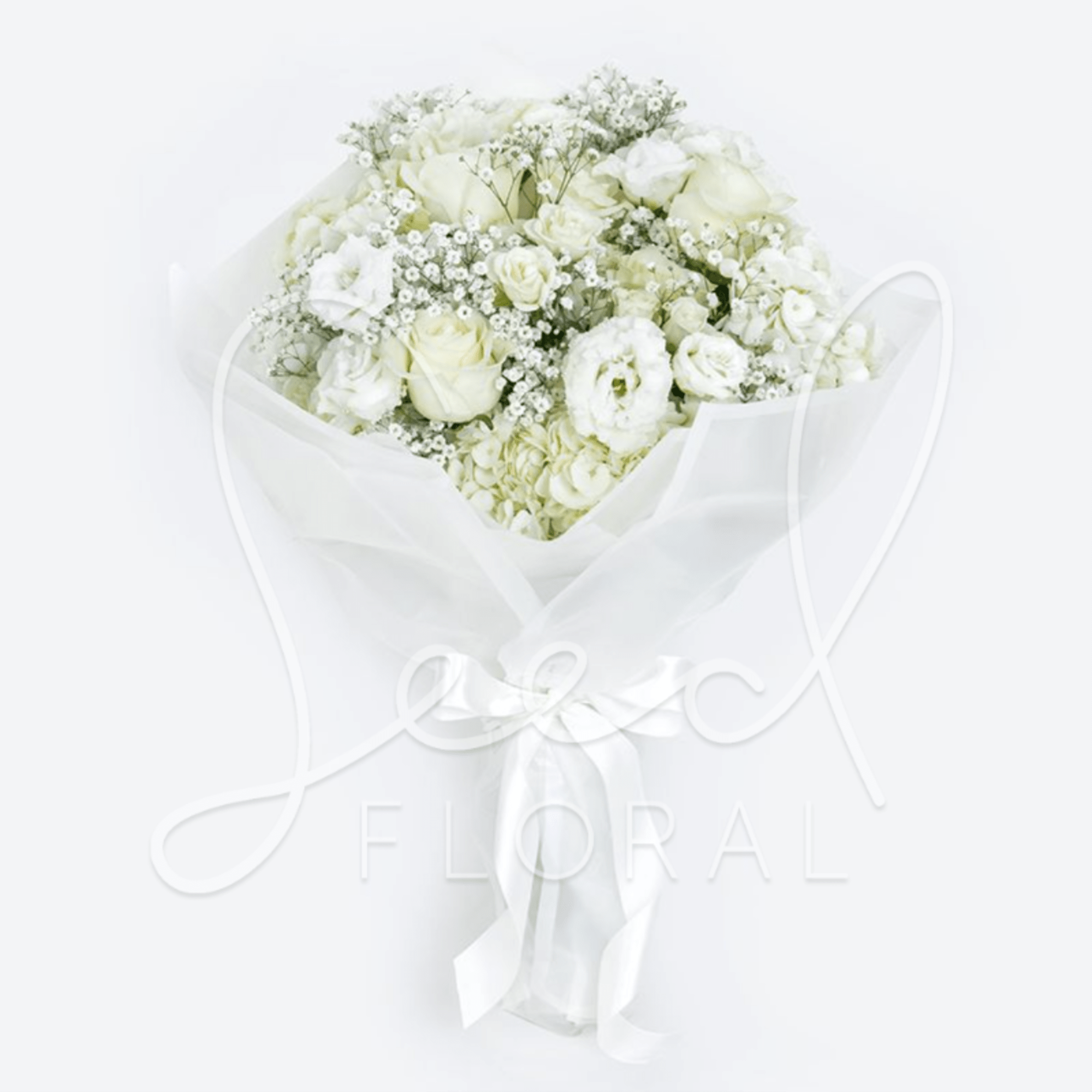 Hand-tied bouquet of white roses, lisianthus, hydrangeas, and baby's breath wrapped in white paper with ribbon