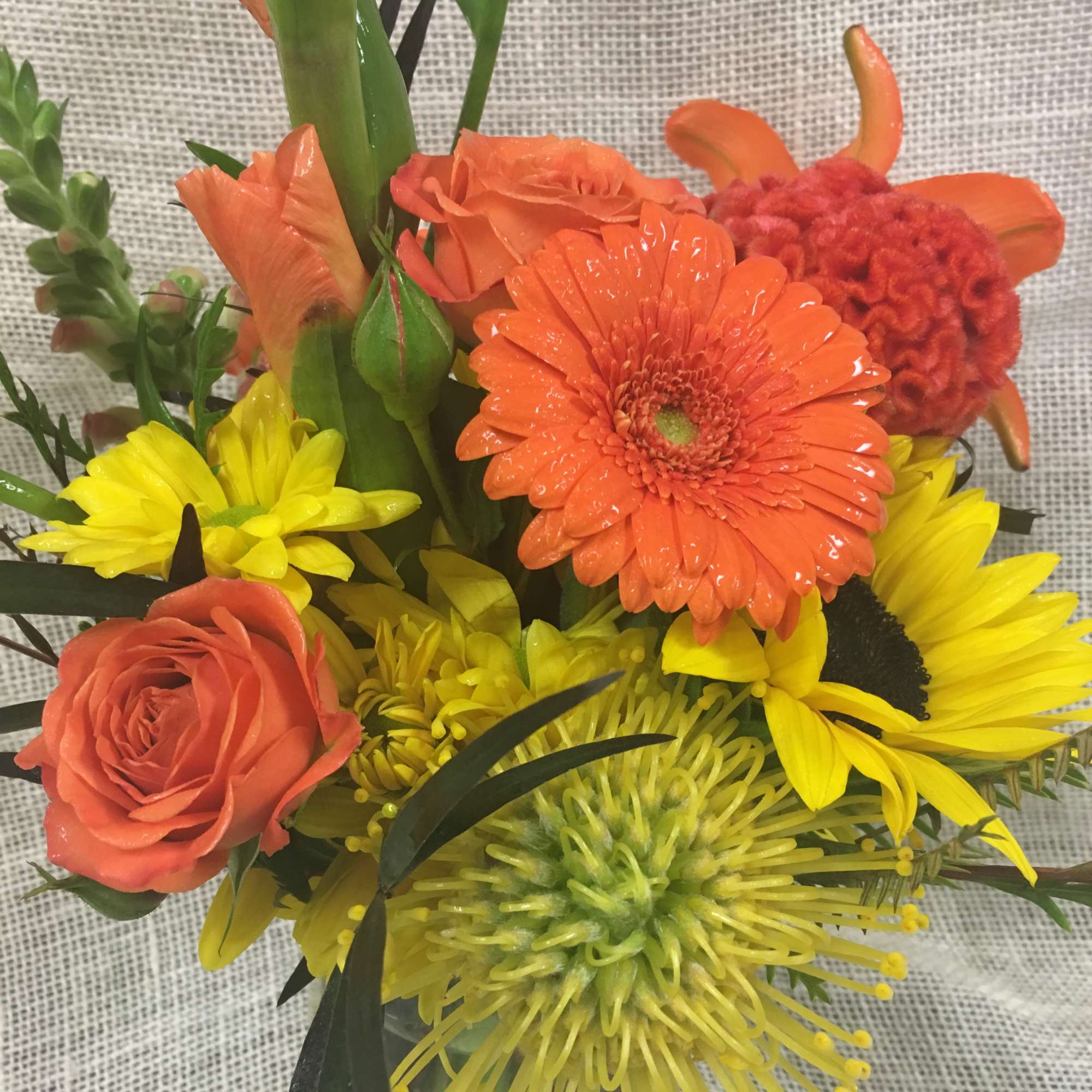 Orange and yellow mixed bouquet with roses, gerbera daisies, and spider mums