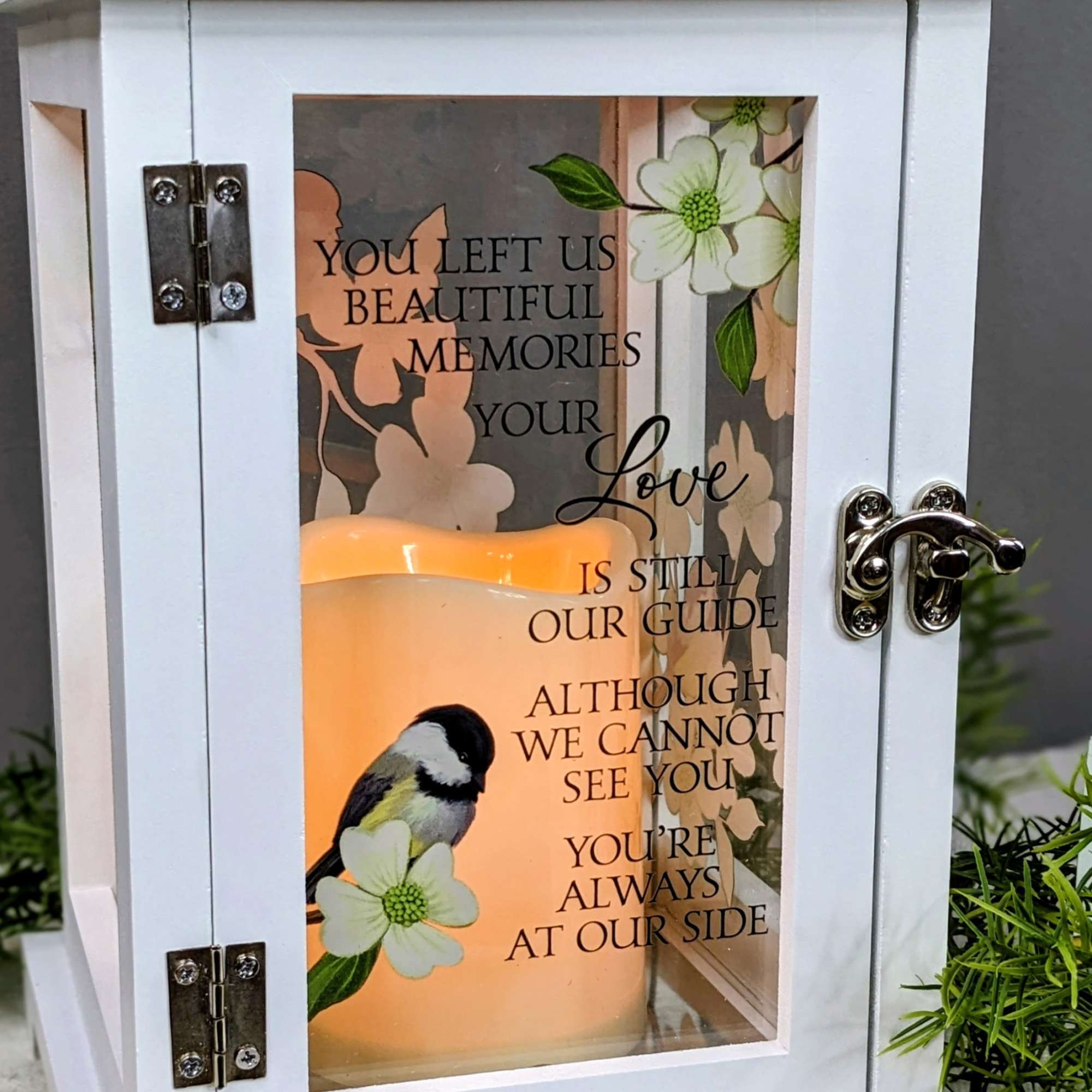 White memorial lantern with gold metal top, printed flowers, bird art, and glowing candle inside