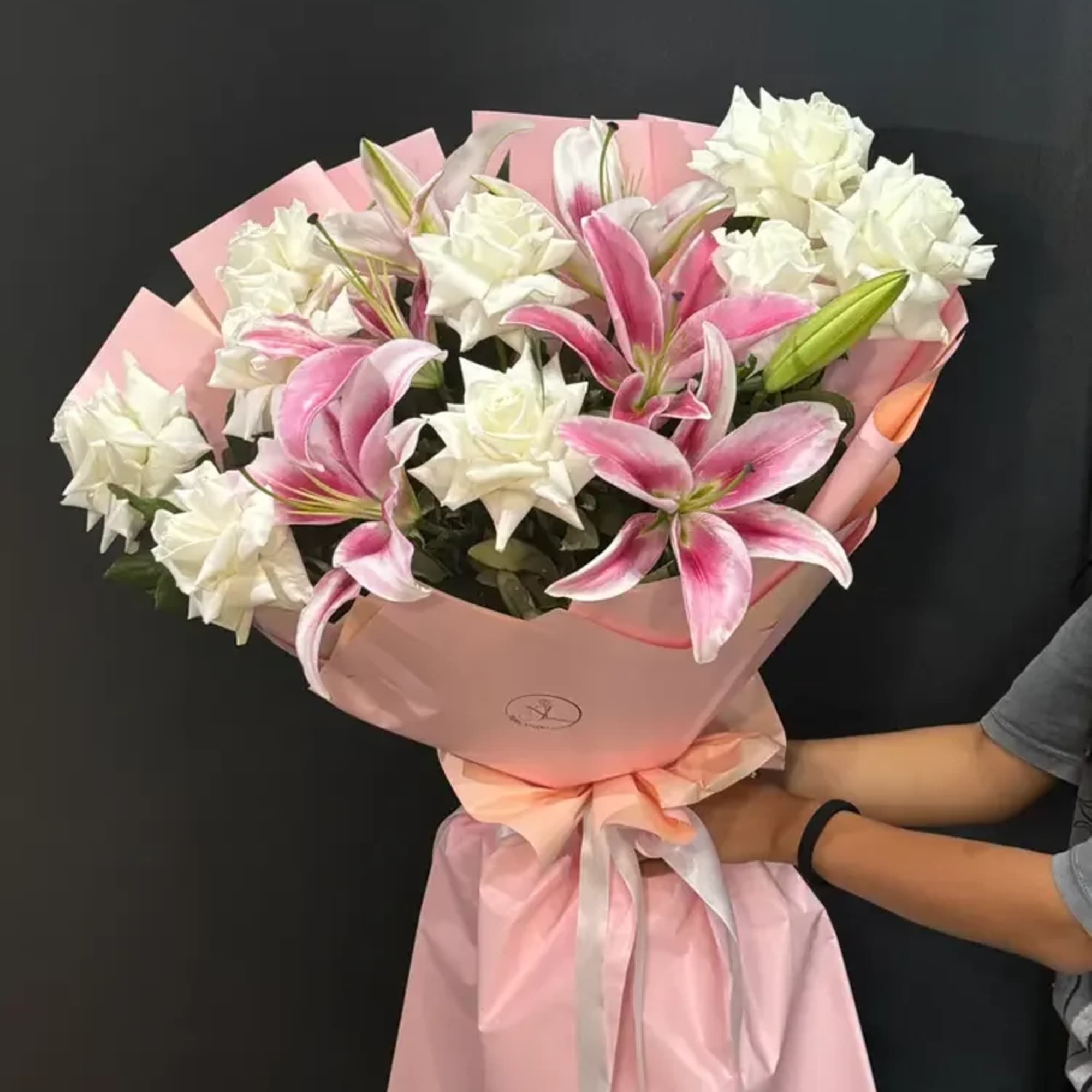 Blush Lily Charm is a timeless and expressive bouquet that combines the