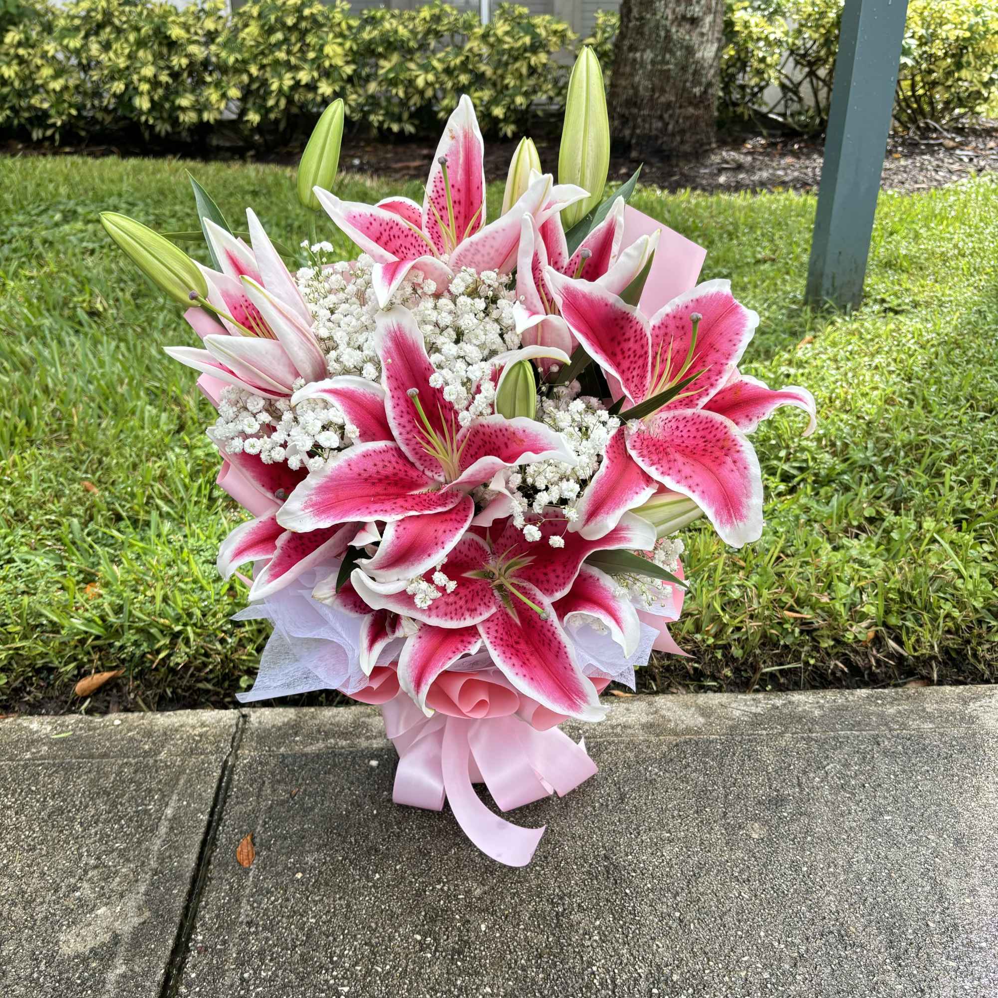 Pink and white lily bouquet with baby's breath and ribbon wrap