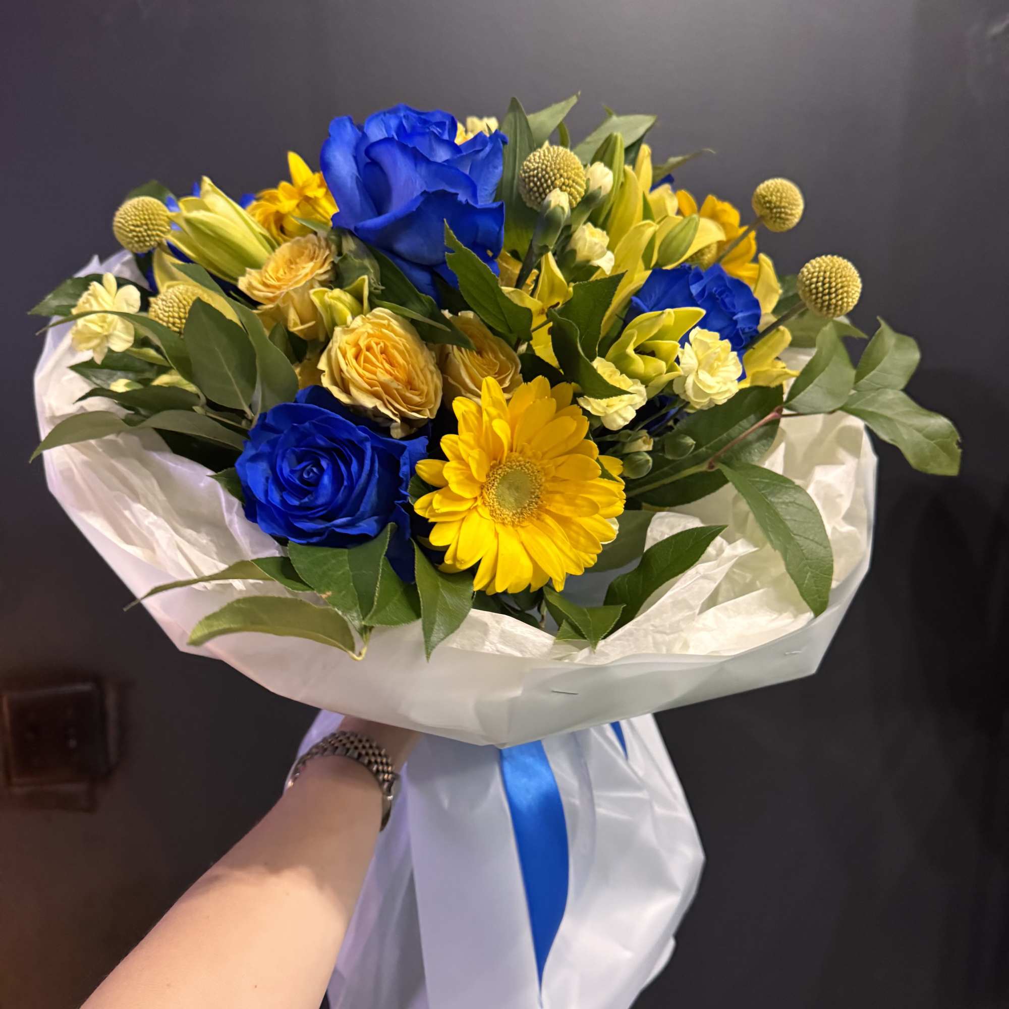 Golden Blue Harmony is a striking bouquet that captures attention with its