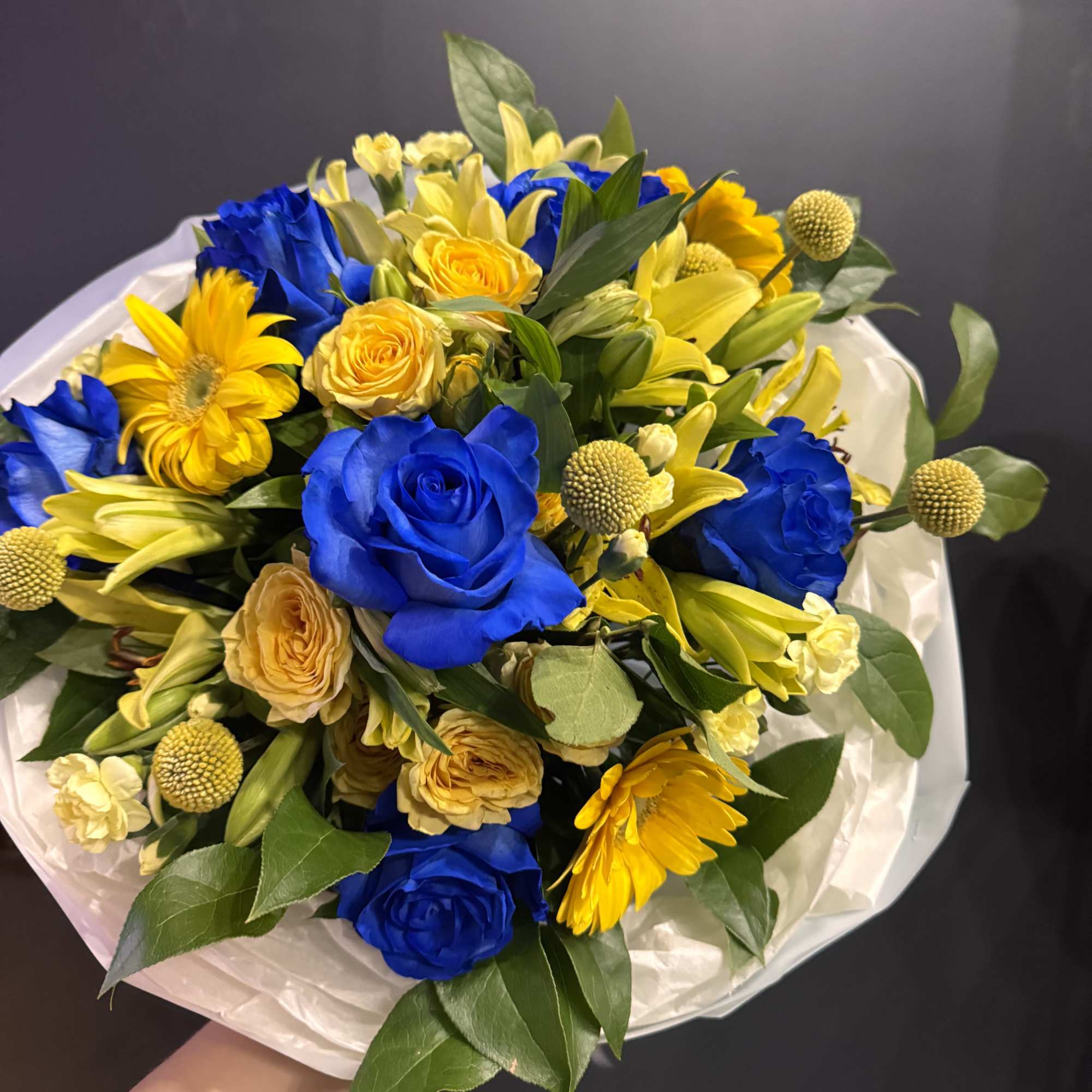 Golden Blue Harmony is a striking bouquet that captures attention with its