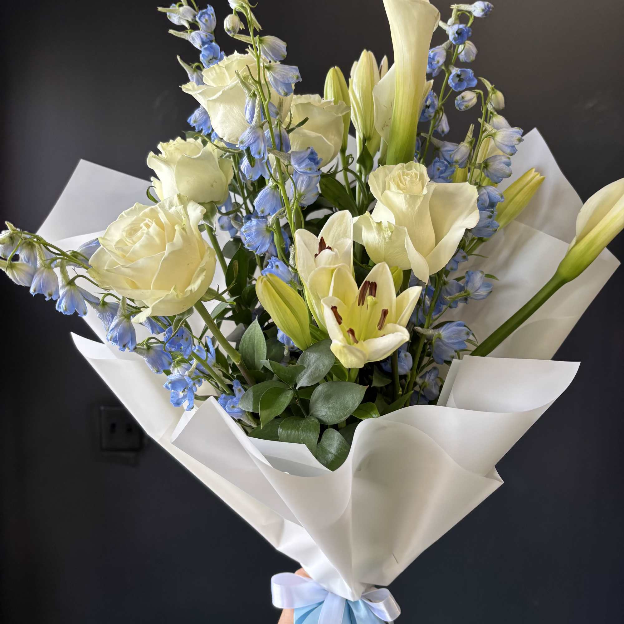A refined and airy arrangement featuring a statement ivory calla lily, creamy