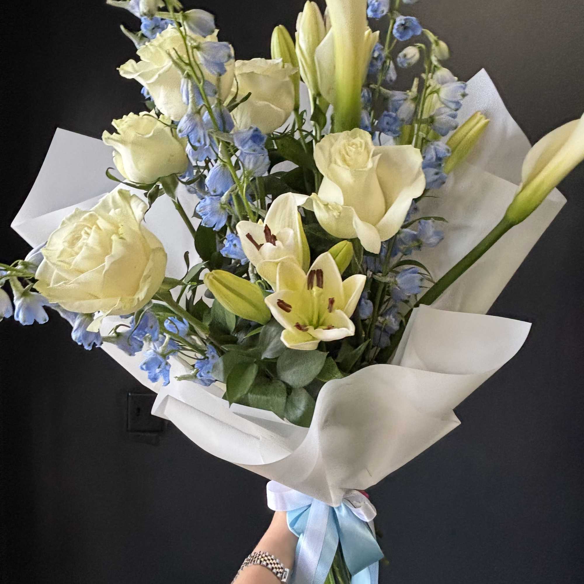 A refined and airy arrangement featuring a statement ivory calla lily, creamy