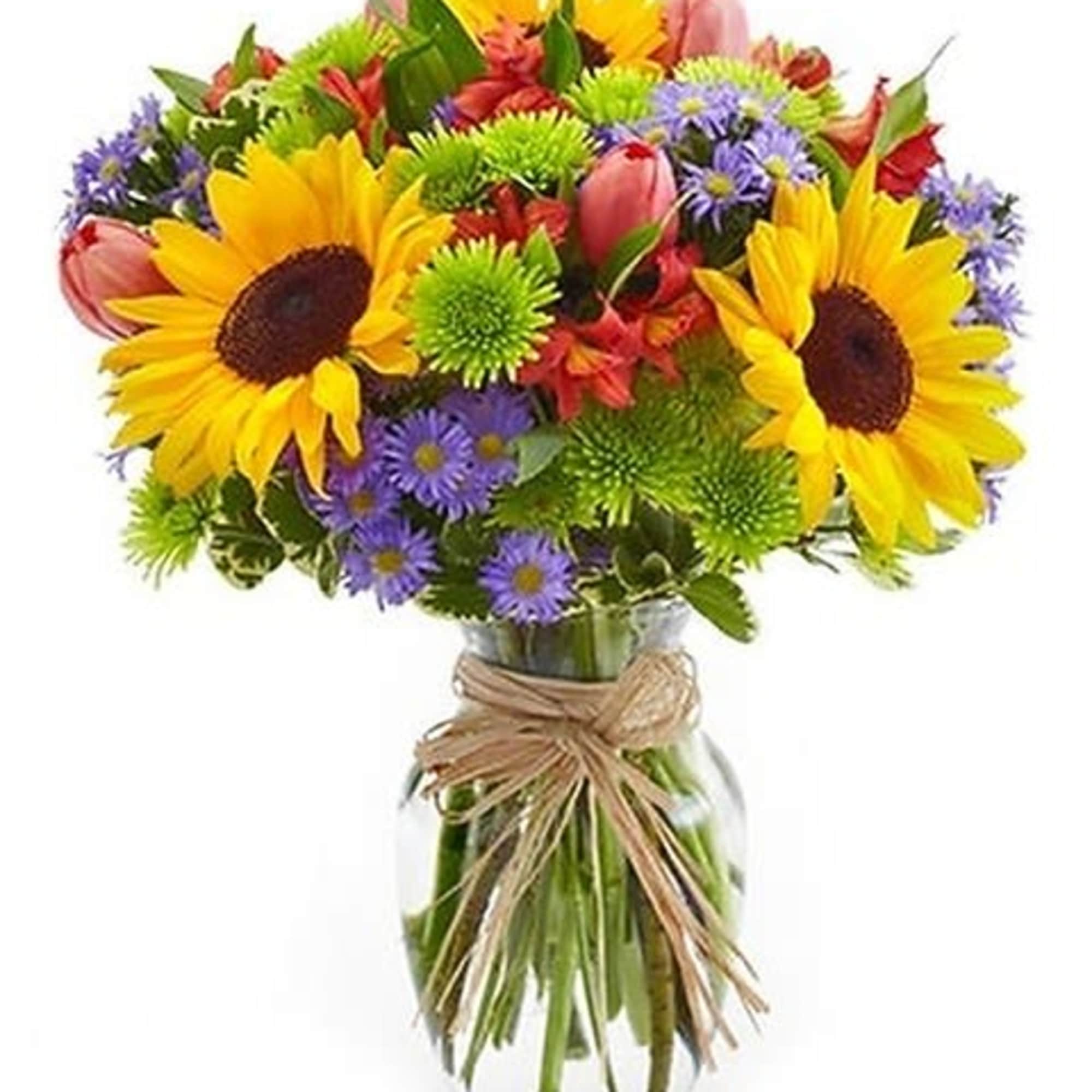 A burst of brilliant flowers in a clear glass vase - a