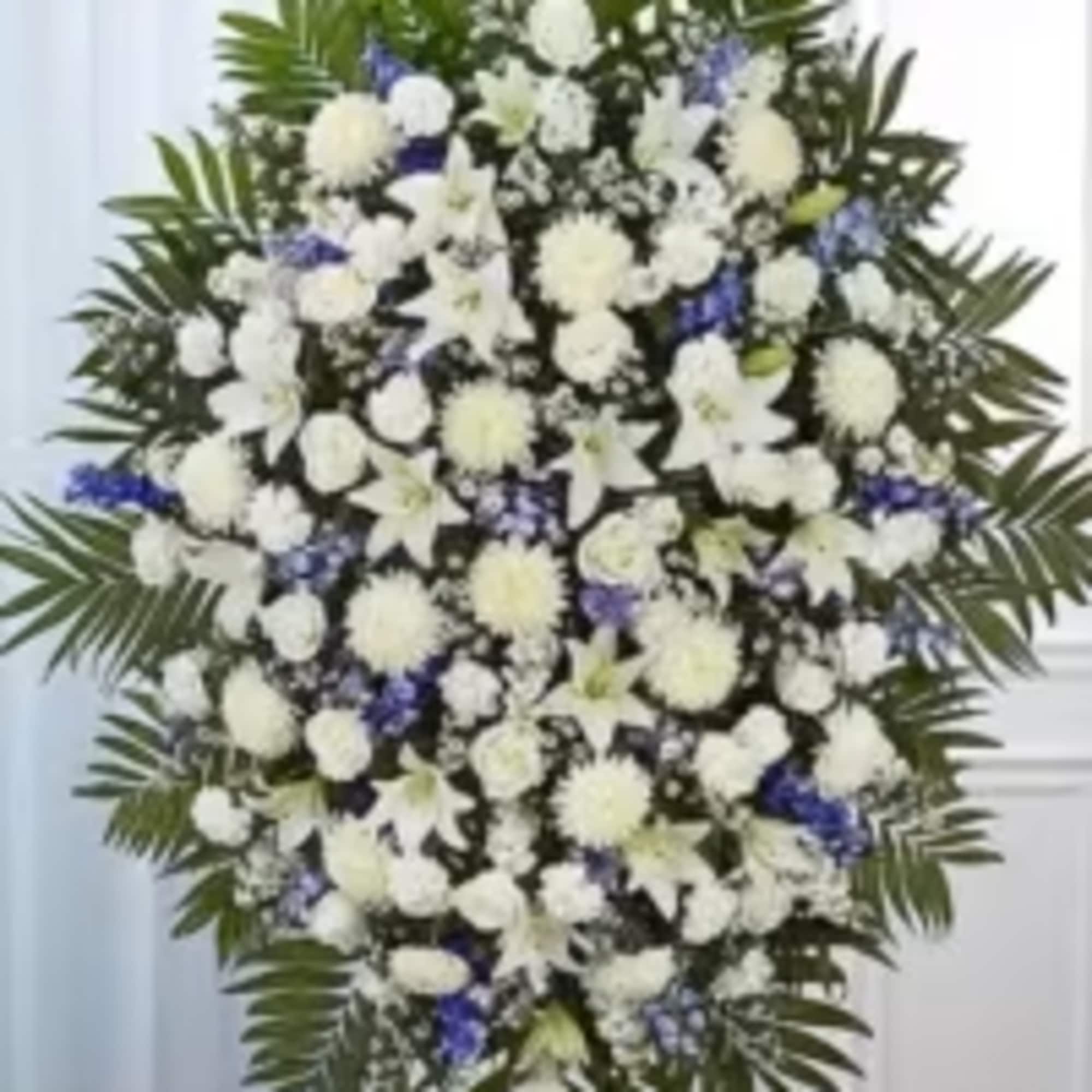 A graceful and elegant blue and white standing sympathy spray designed to