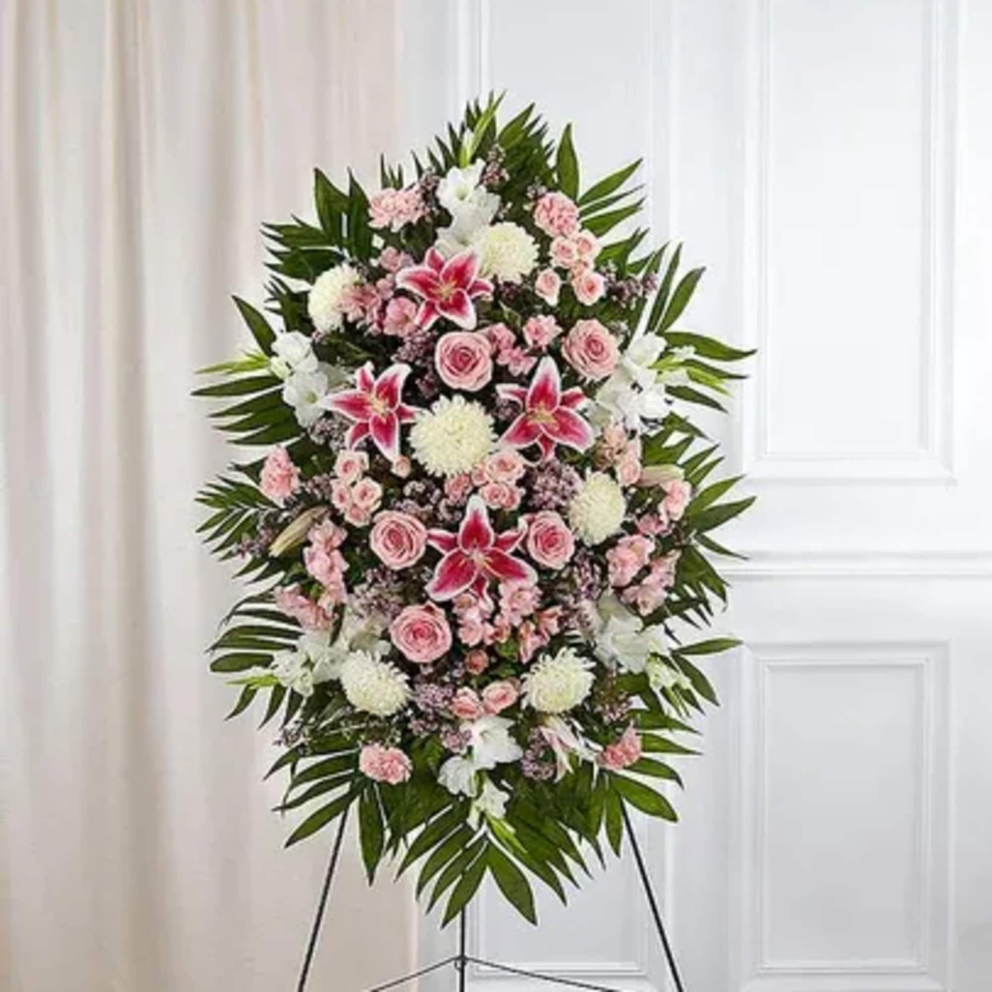 A stunning and elegant standing spray featuring a soft and romantic pink