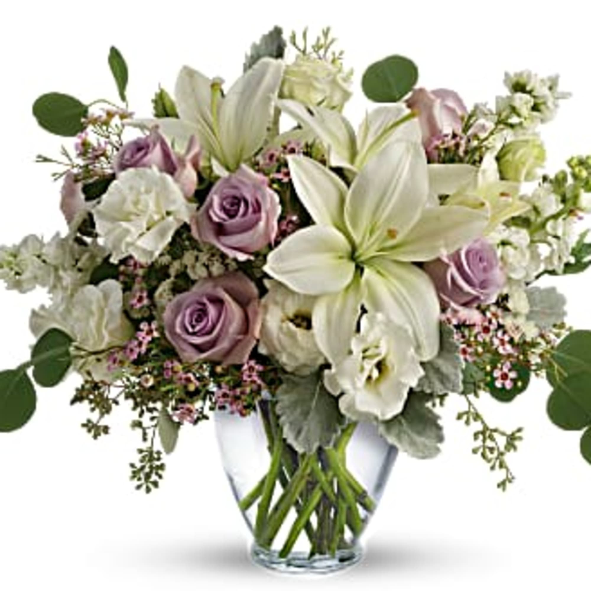 Pastel bouquet of white lilies and lavender roses arranged in a clear glass vase