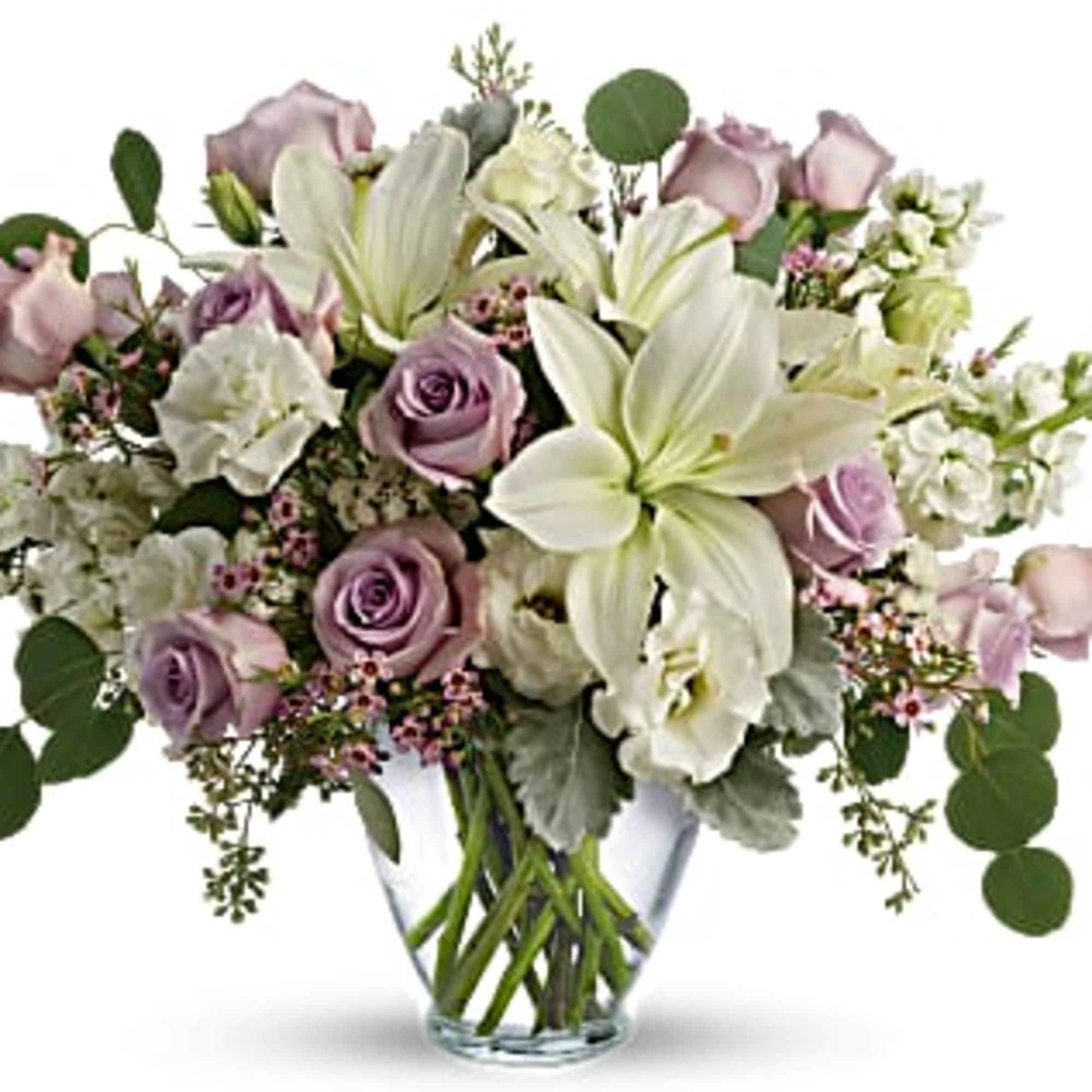 Mixed bouquet of white lilies and lavender roses arranged in a clear glass vase