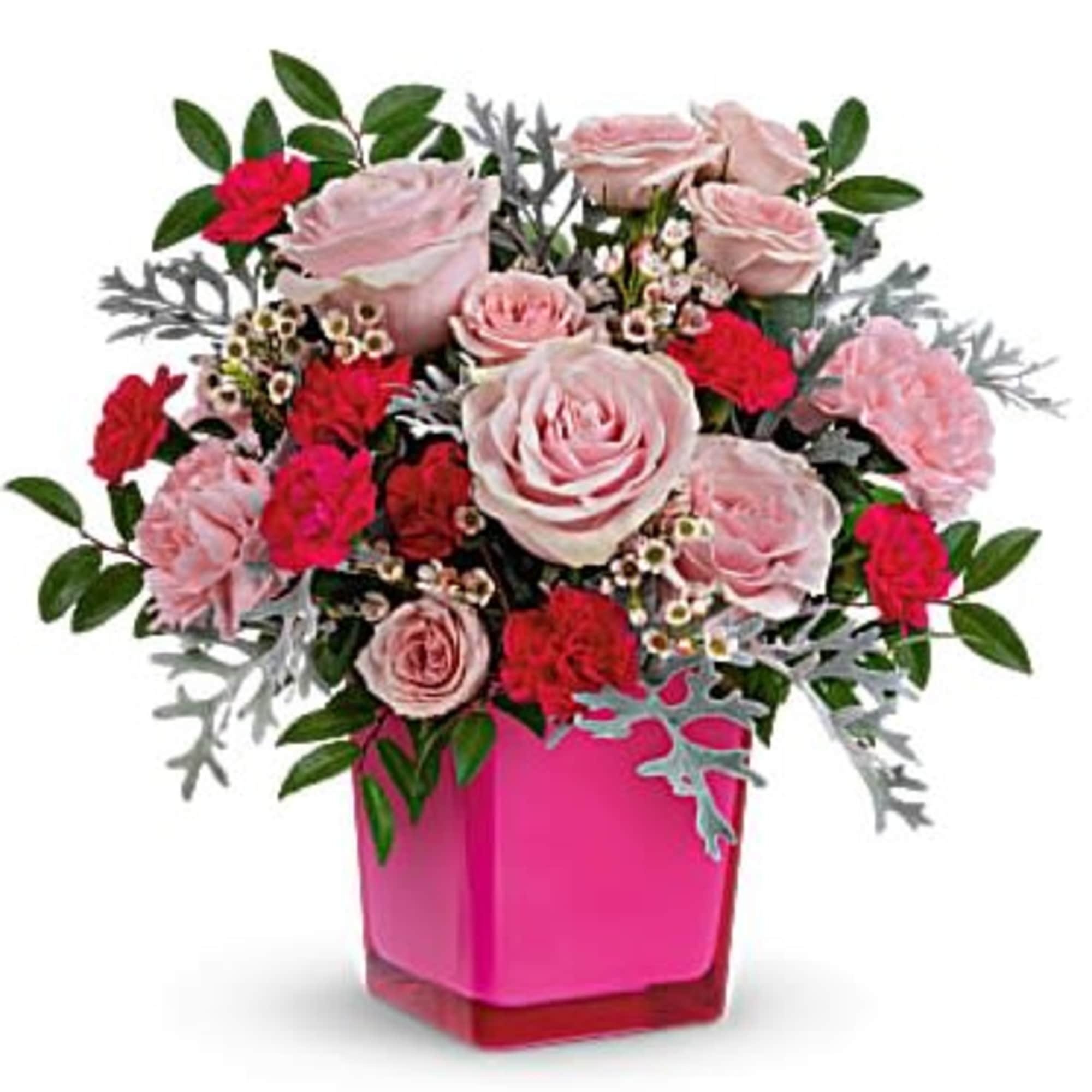 Pink and red rose and carnation arrangement in a bright pink cube vase
