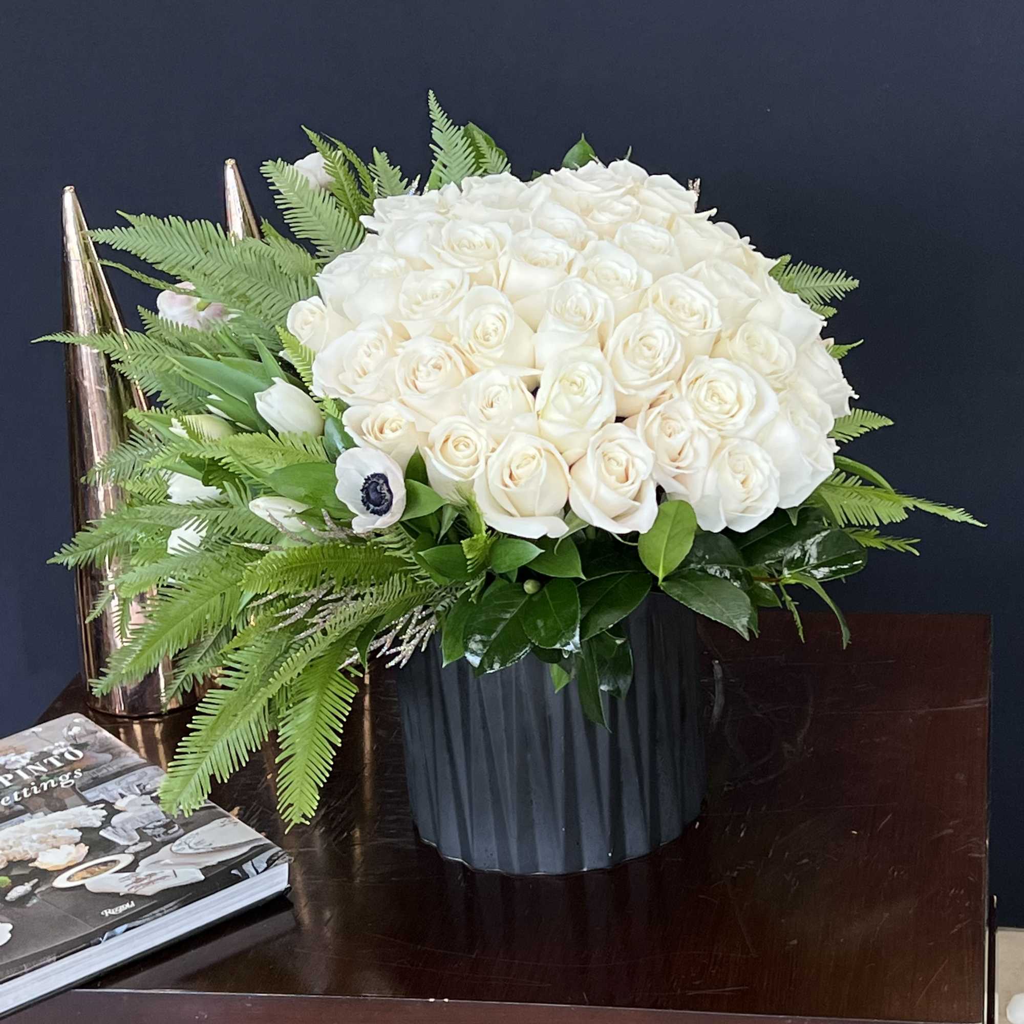 A beautiful bouquet of white Roses, with Tulips and Ferns in a