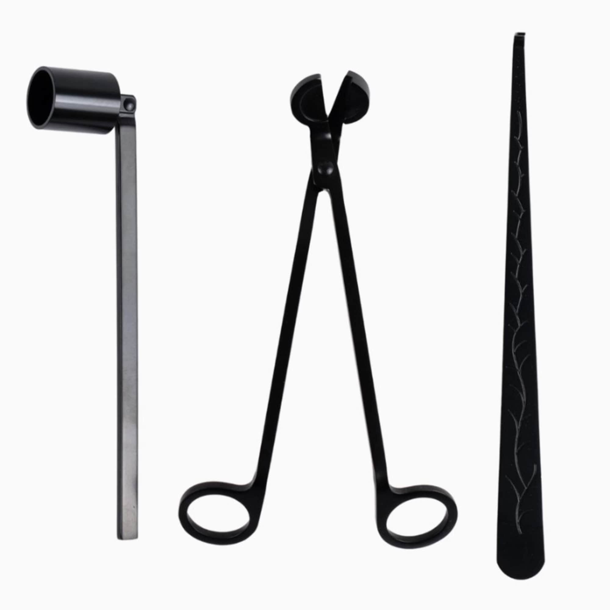 Black floral tools including a clamp, tongs, and tweezers on a white background
