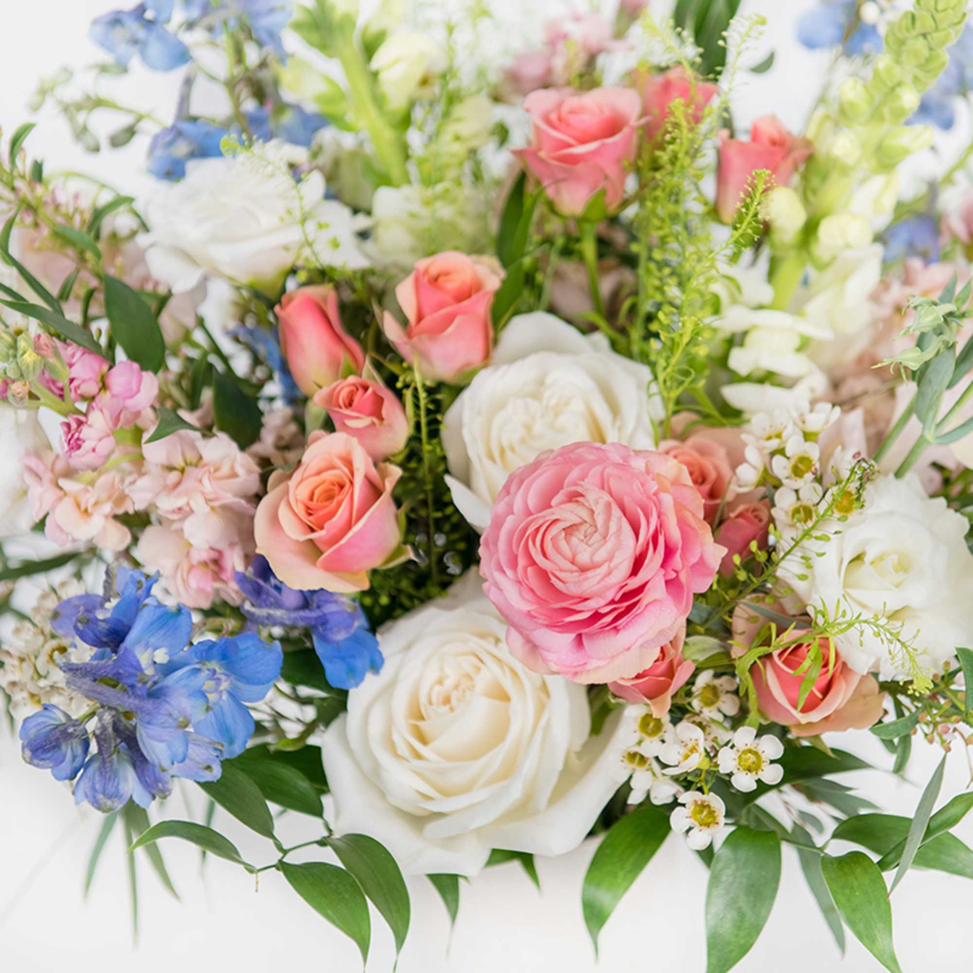Bouquet of pink and white roses with blue flowers