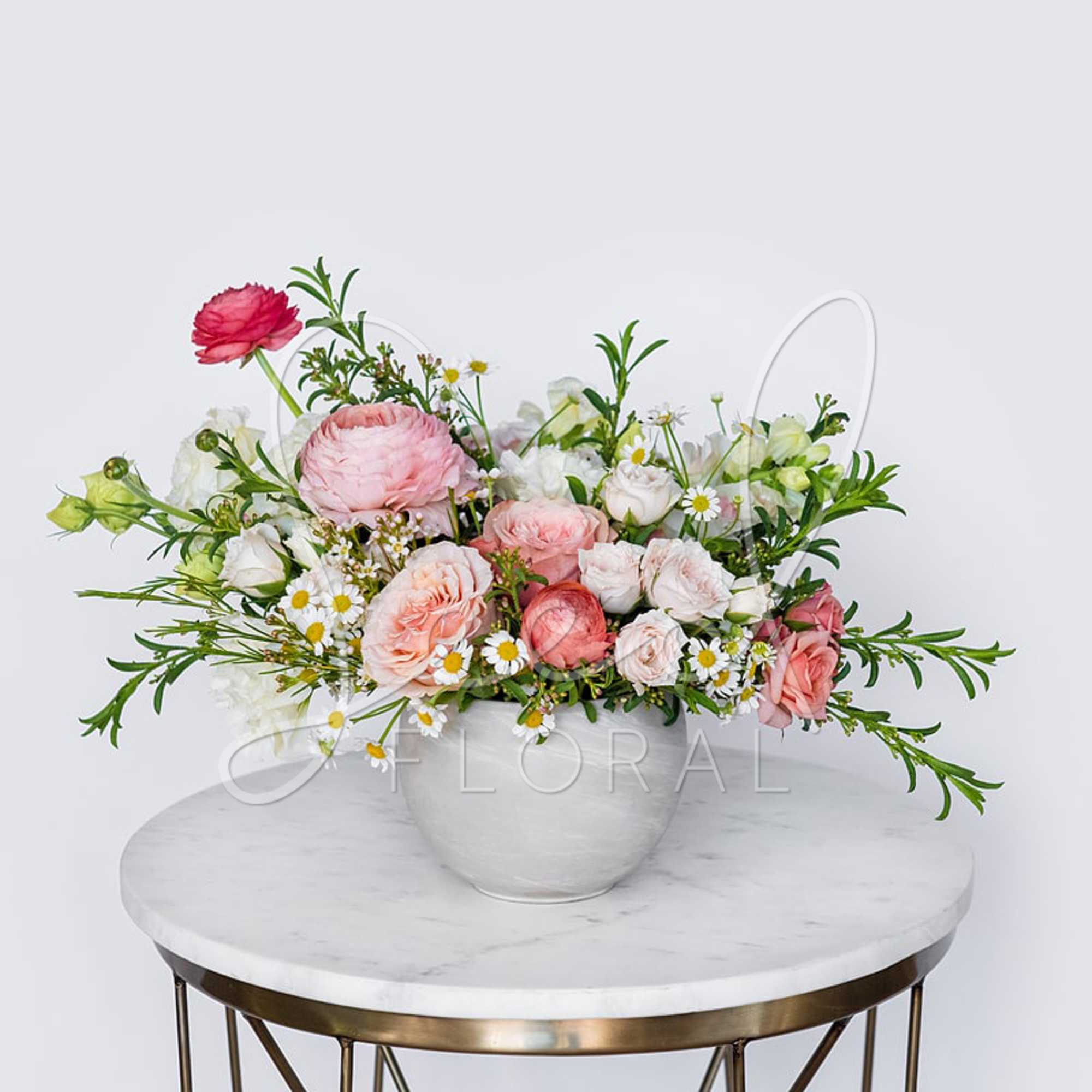 Pink and white mixed flower arrangement in a white vase