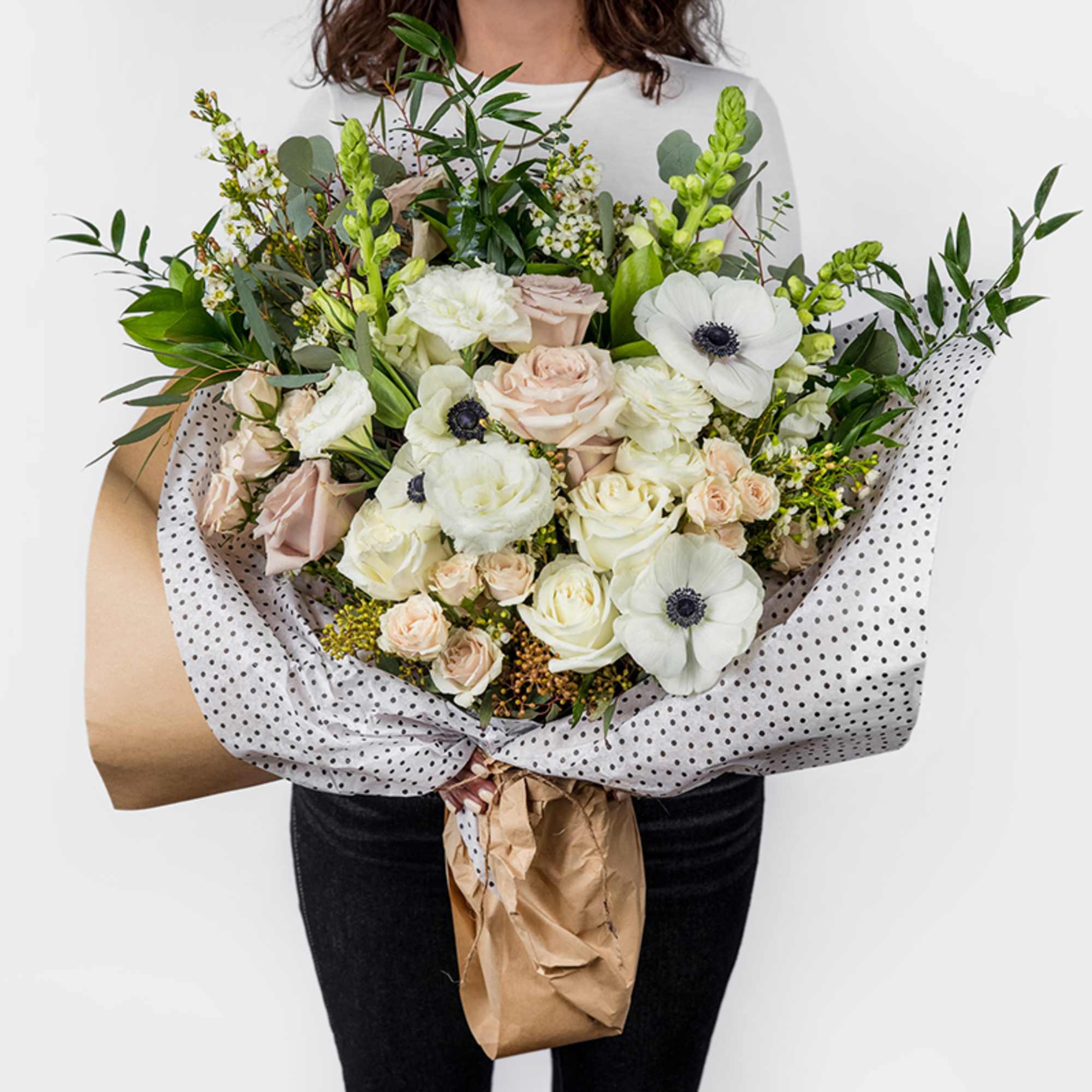 Designed in-house with a serene palette of seasonal neutral flowers. This exquisite