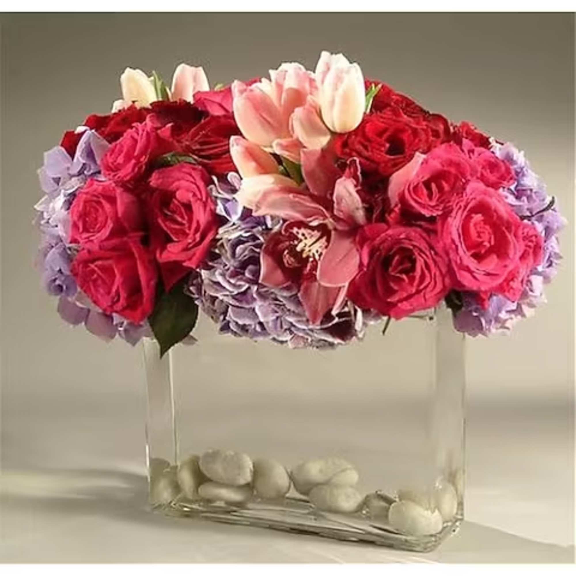 A contemporary design consisting of hydrangea, roses, tulips and cymbidium orchid blossoms