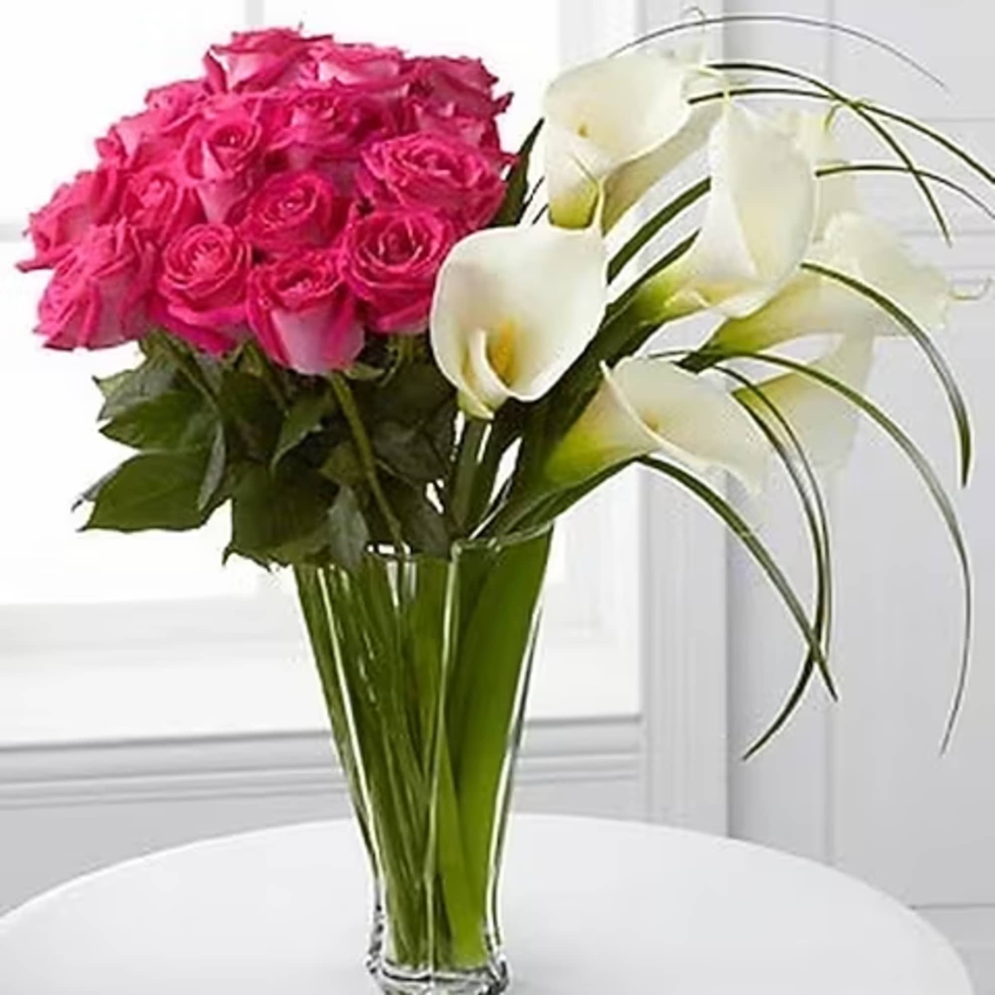 Blooming with roses and open-cut calla lilies, this exquisite flower bouquet will