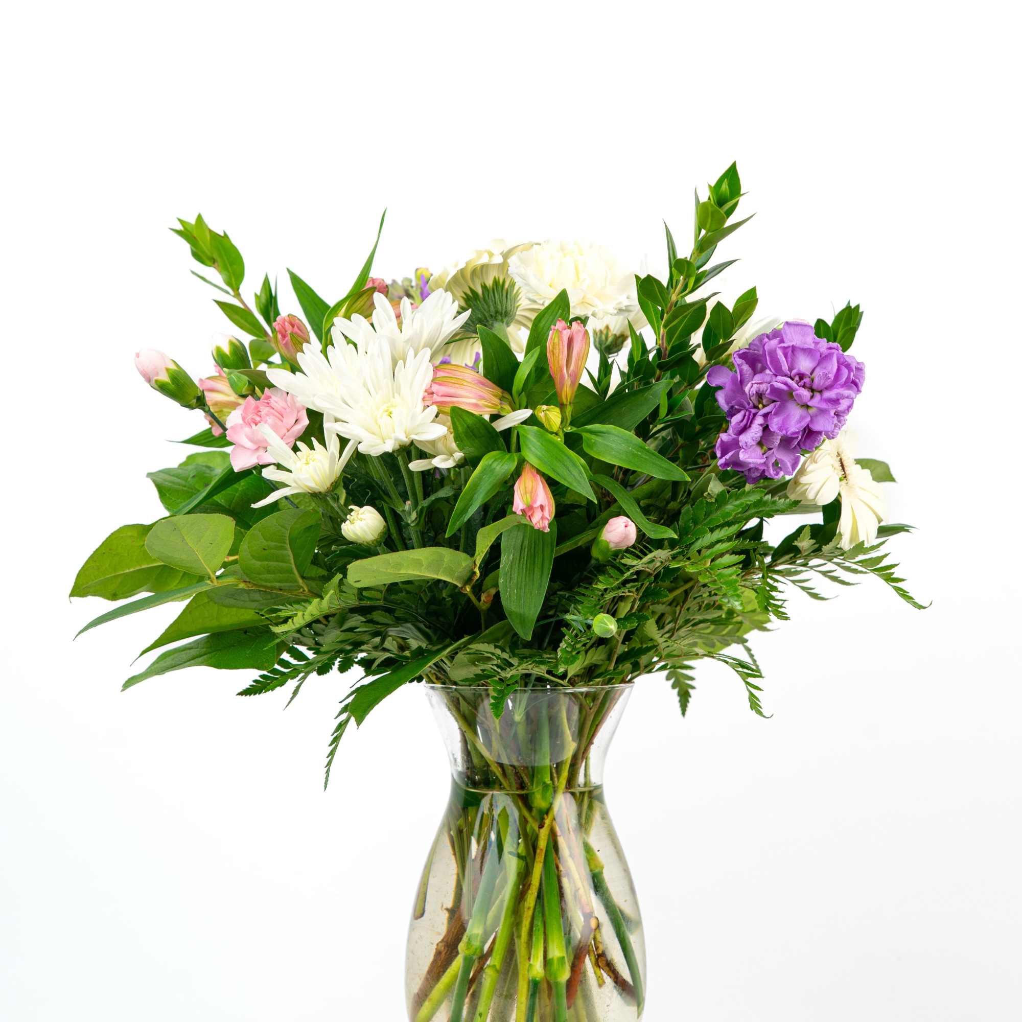 Mixed bouquet of white mums, pink alstroemeria, and a purple carnation in a clear glass vase
