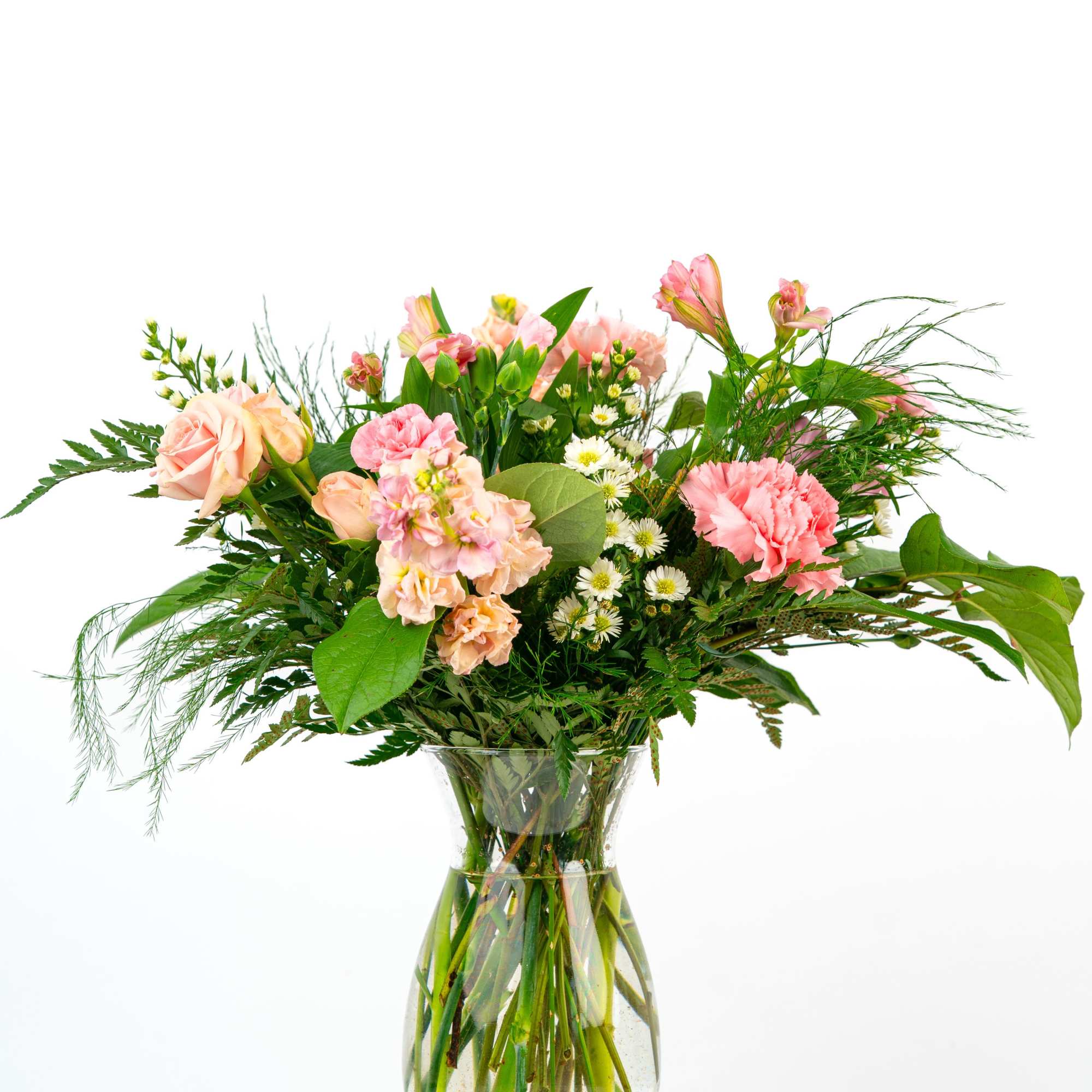 Pink and peach mixed flowers with white daisies arranged in a clear glass vase
