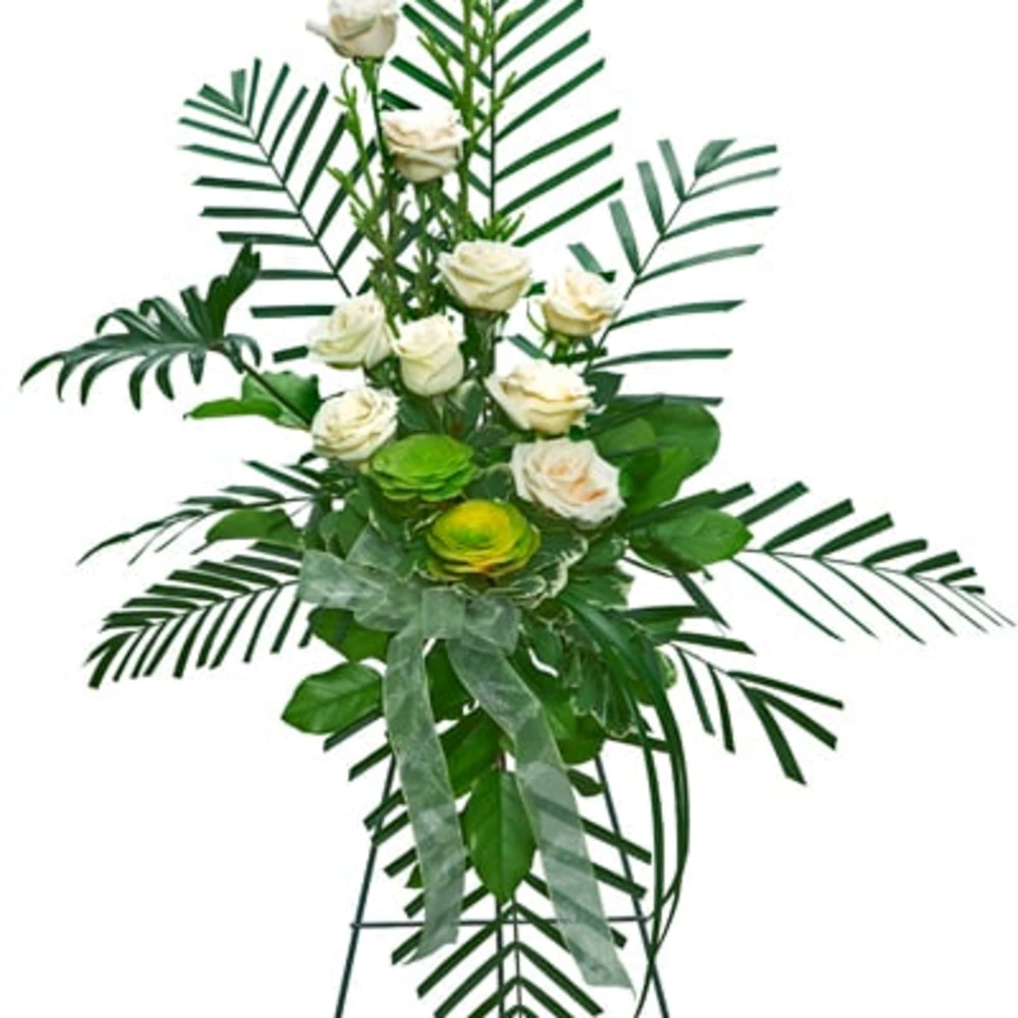 Tall standing arrangement of white roses and palm leaves on an easel.