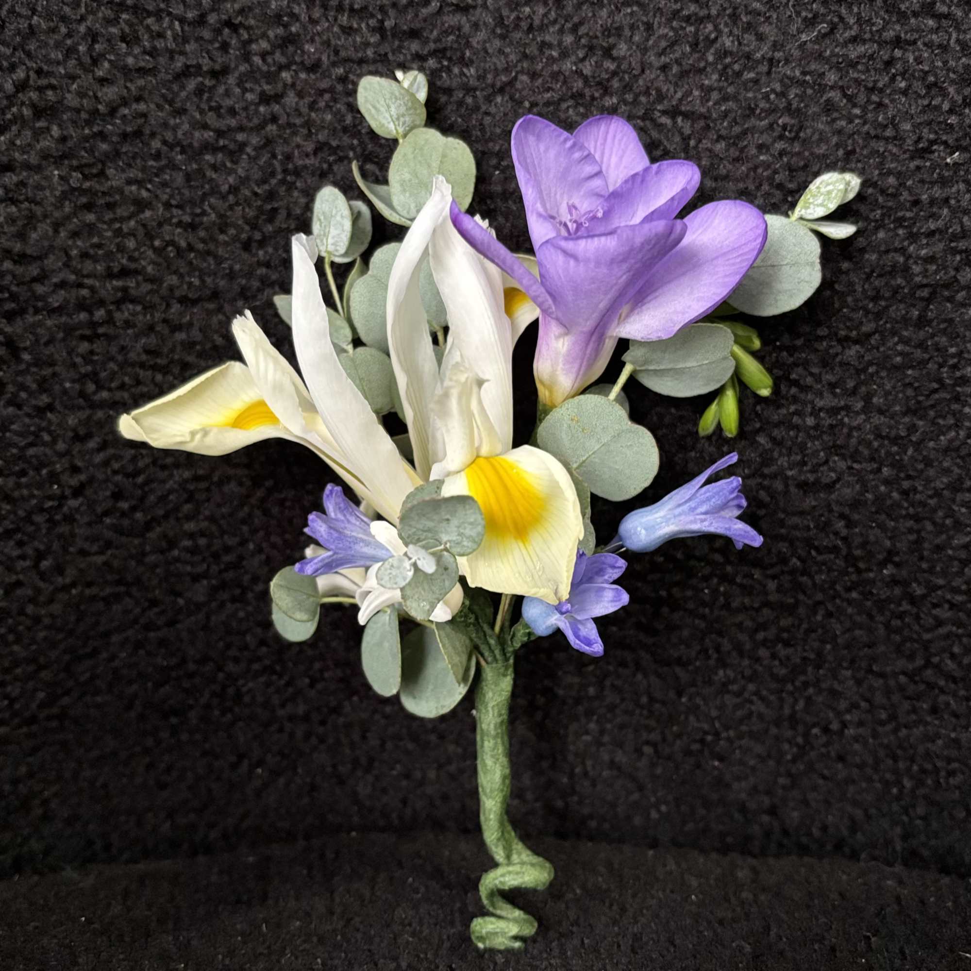 Whispering Garden Boutonni&egrave;re is a refined floral accent designed to complement a
