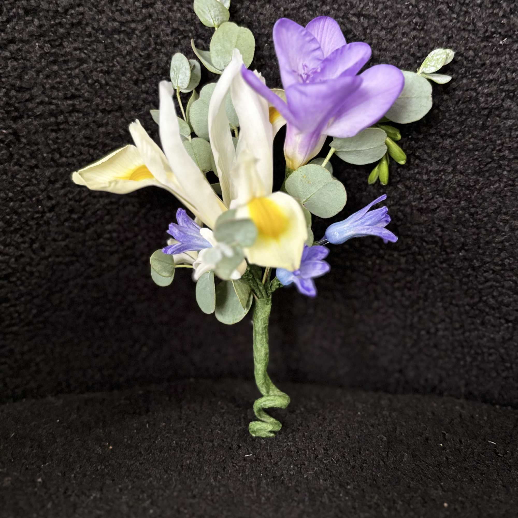 Whispering Garden Boutonni&egrave;re is a refined floral accent designed to complement a