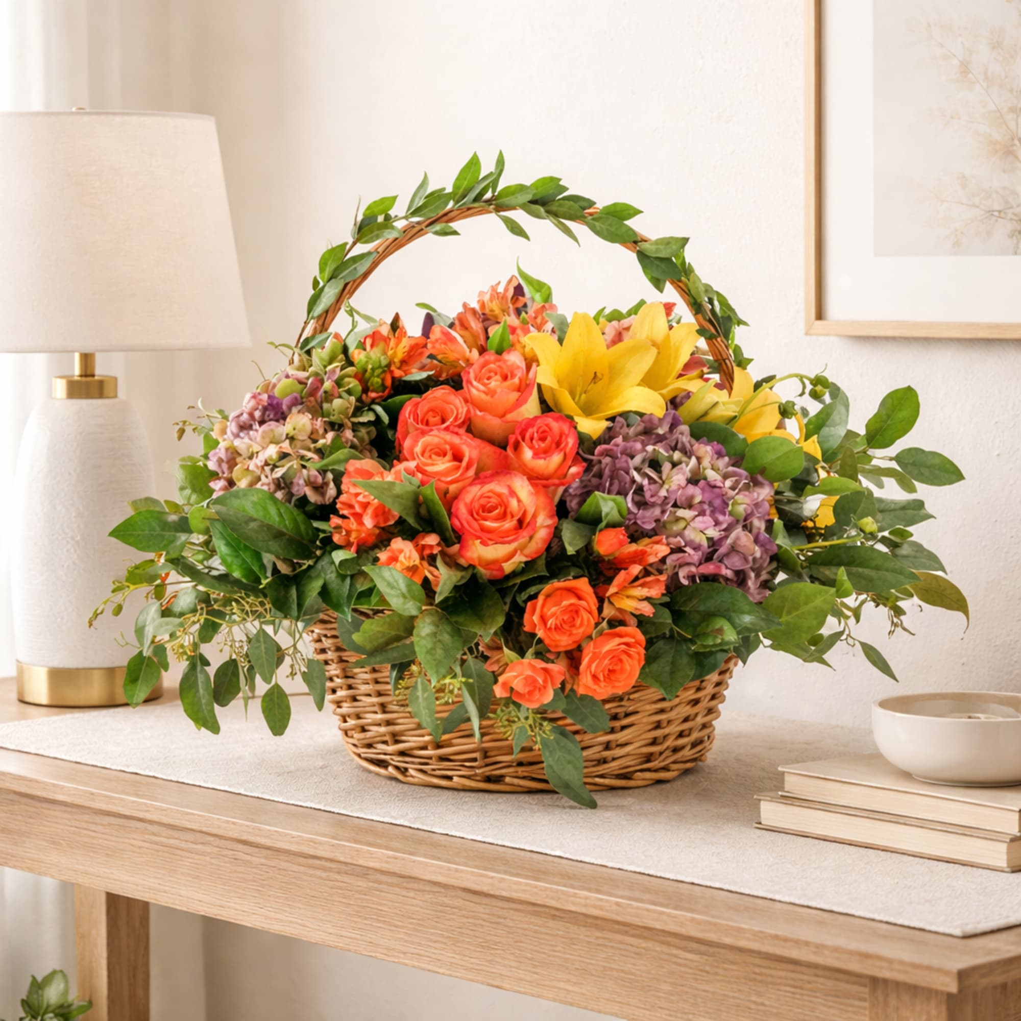 Basket of orange roses, yellow lilies, and purple hydrangeas